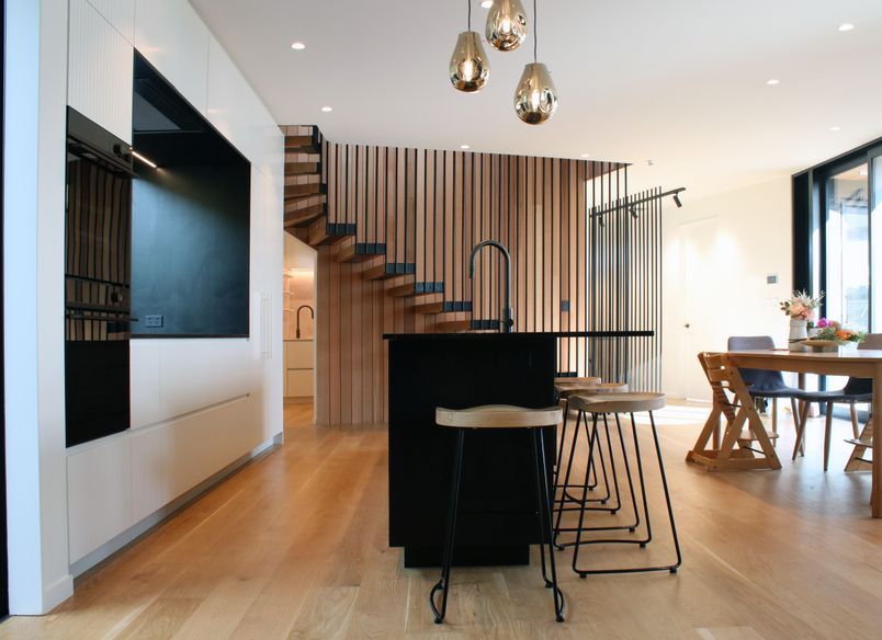 White V groove, black island and a scullery with a touch of pink