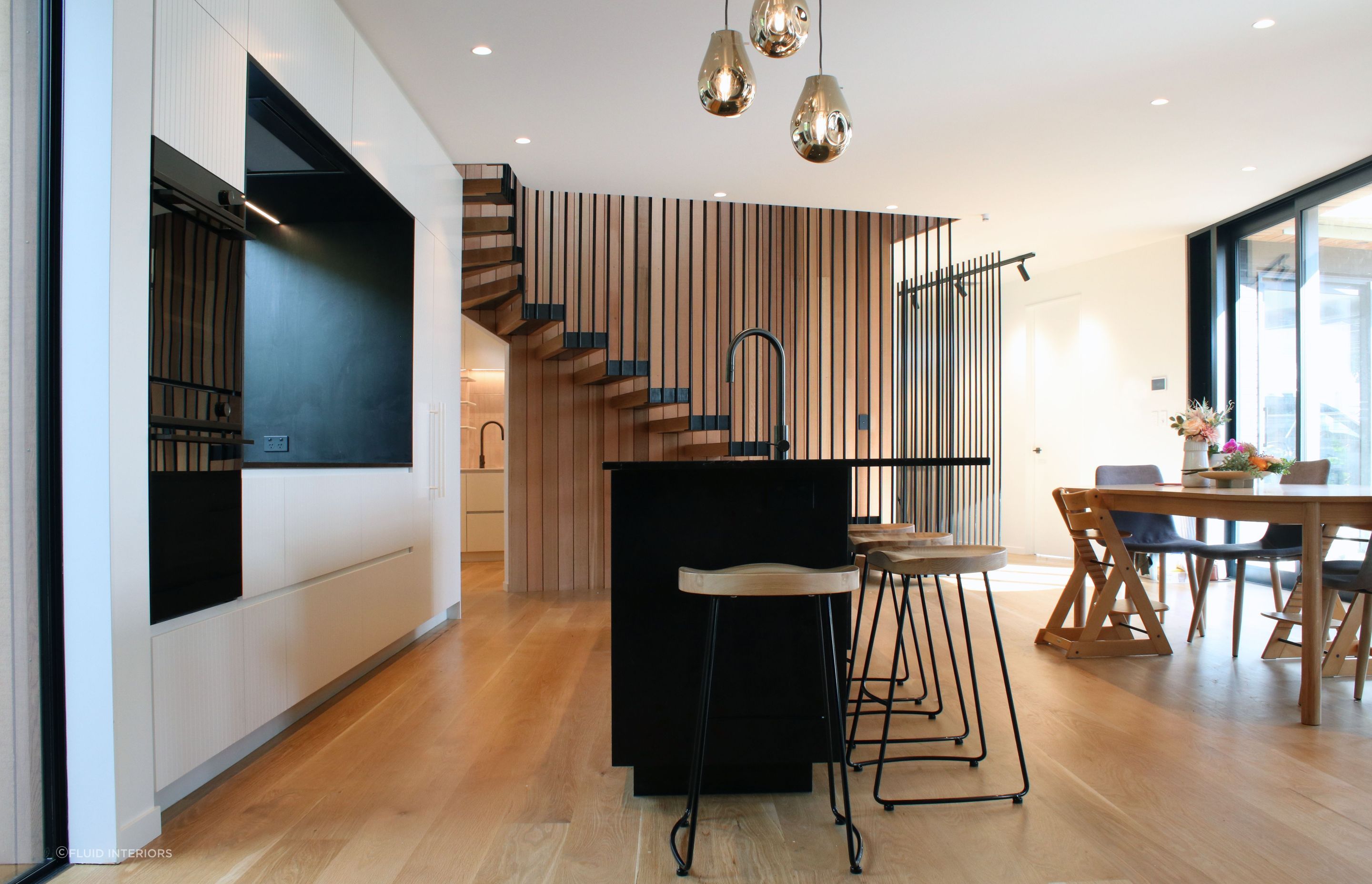 White V groove, black island and a scullery with a touch of pink