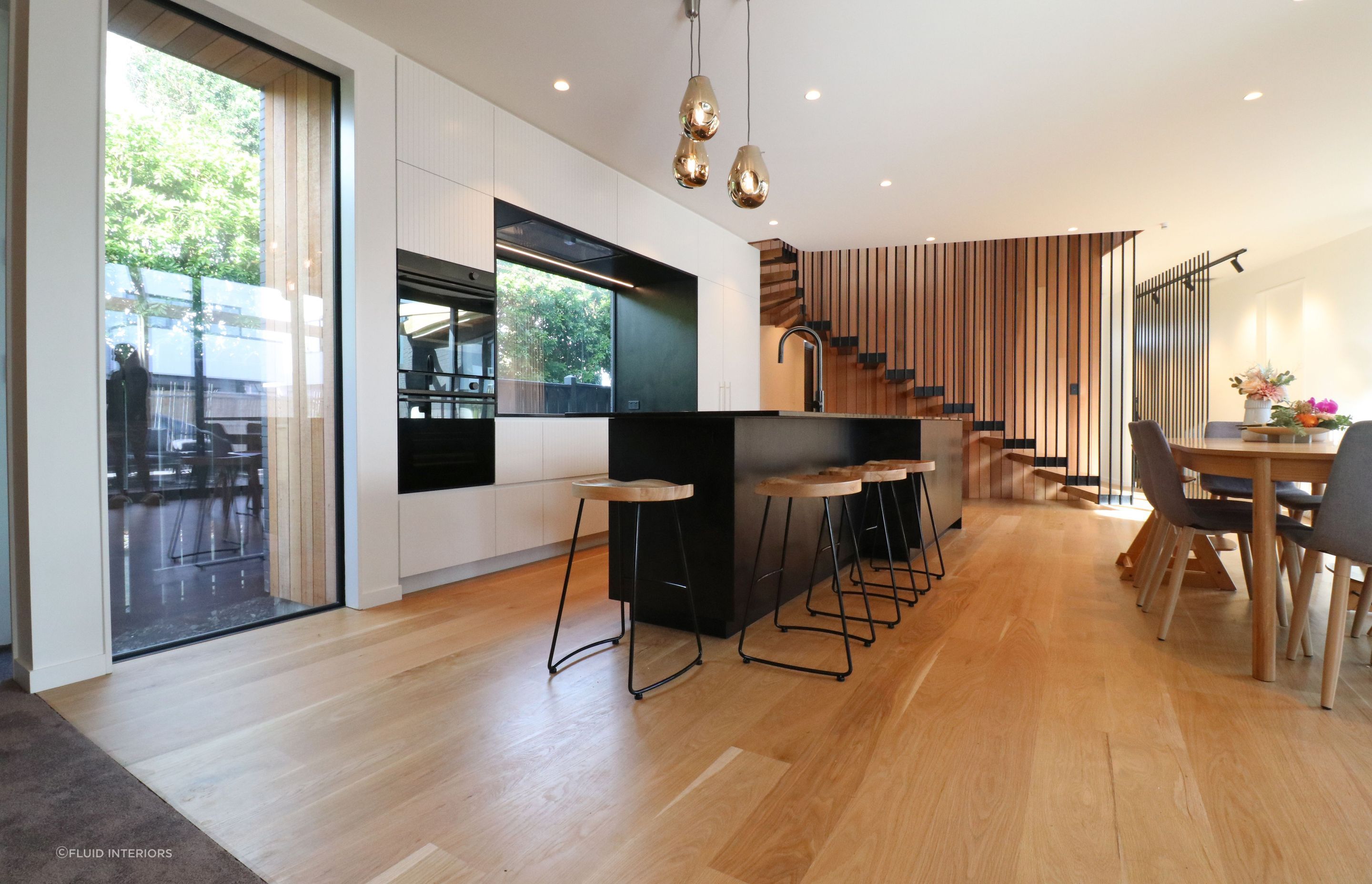 White V groove, black island and a scullery with a touch of pink
