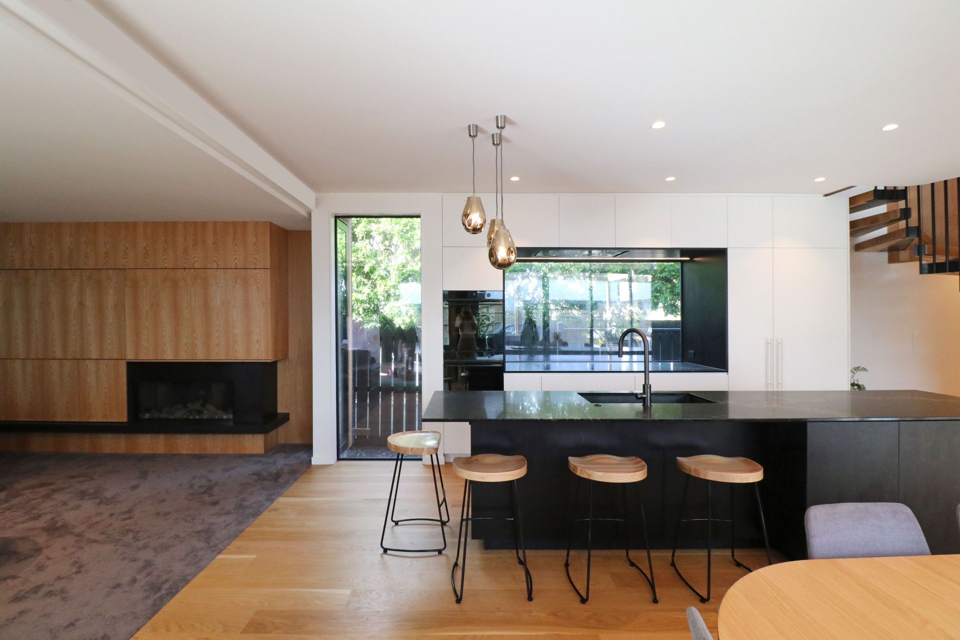 White V groove, black island and a scullery with a touch of pink