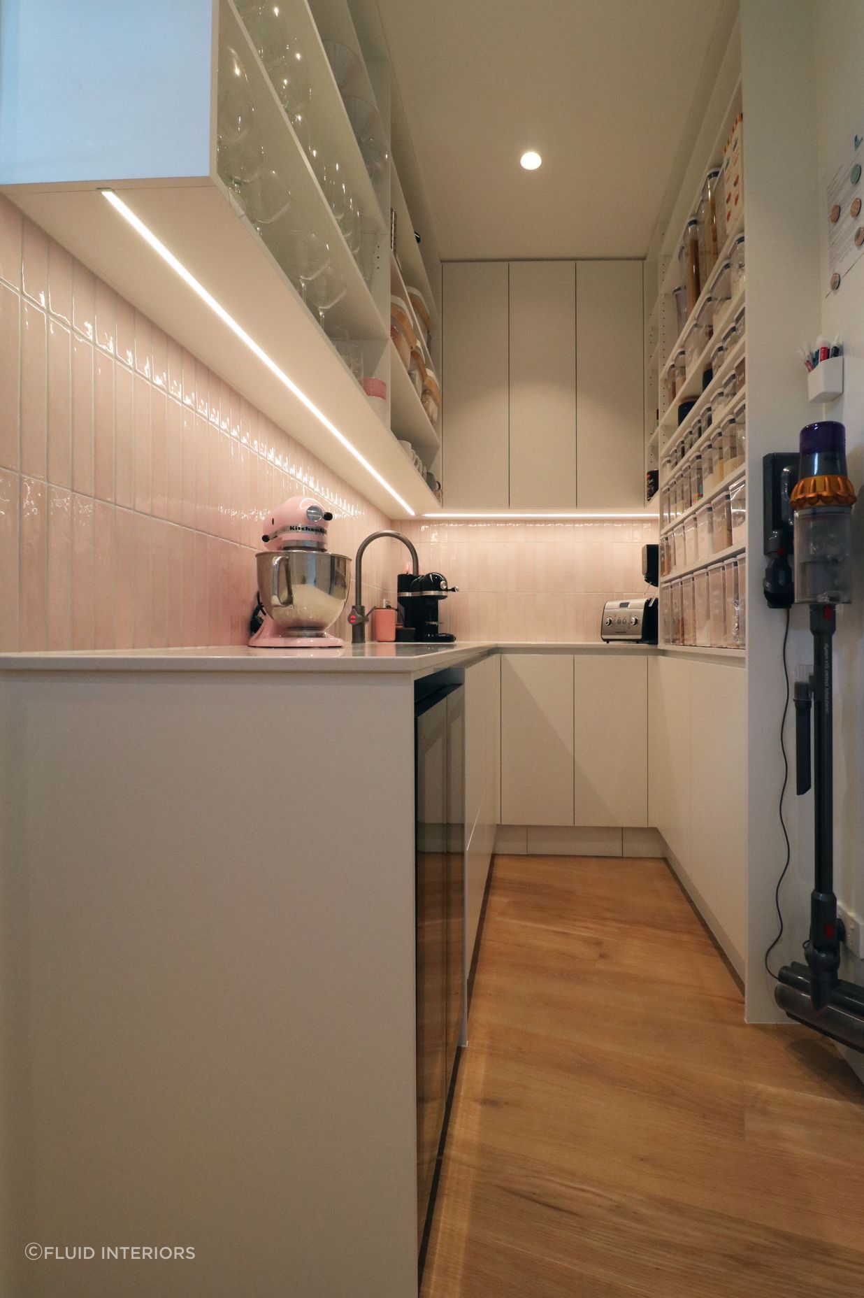 White V groove, black island and a scullery with a touch of pink