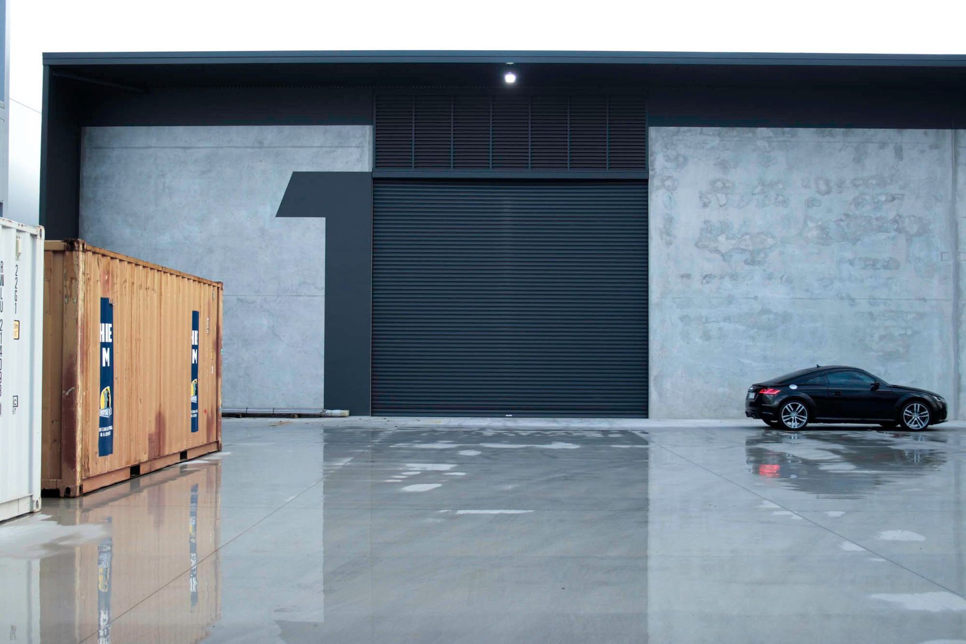 Eniquest Warehouse - Exterior. Tenancy with a large number and roller door.