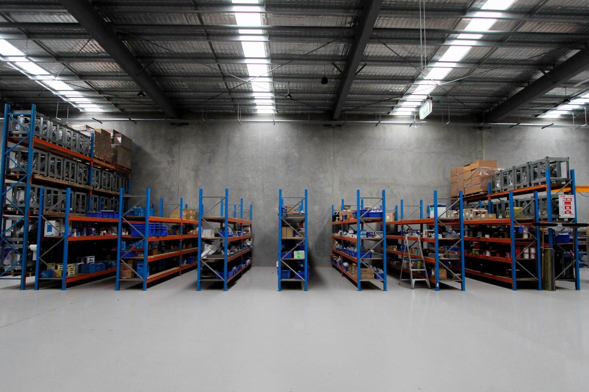 Eniquest Warehouse - Warehouse. Racking and workbenches beneath bright skylights.