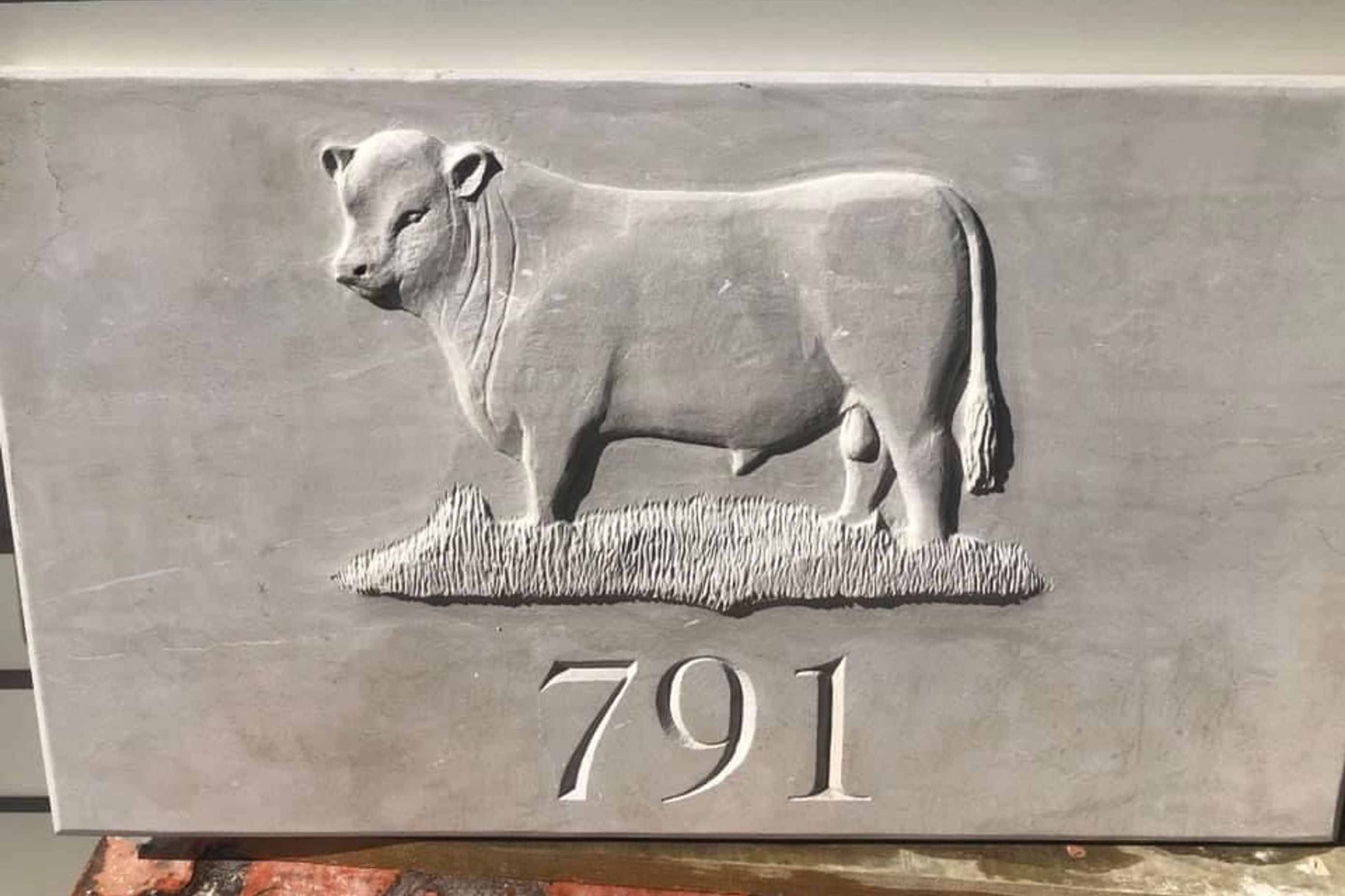Carved bull and house number in limestone by Paul Gautron