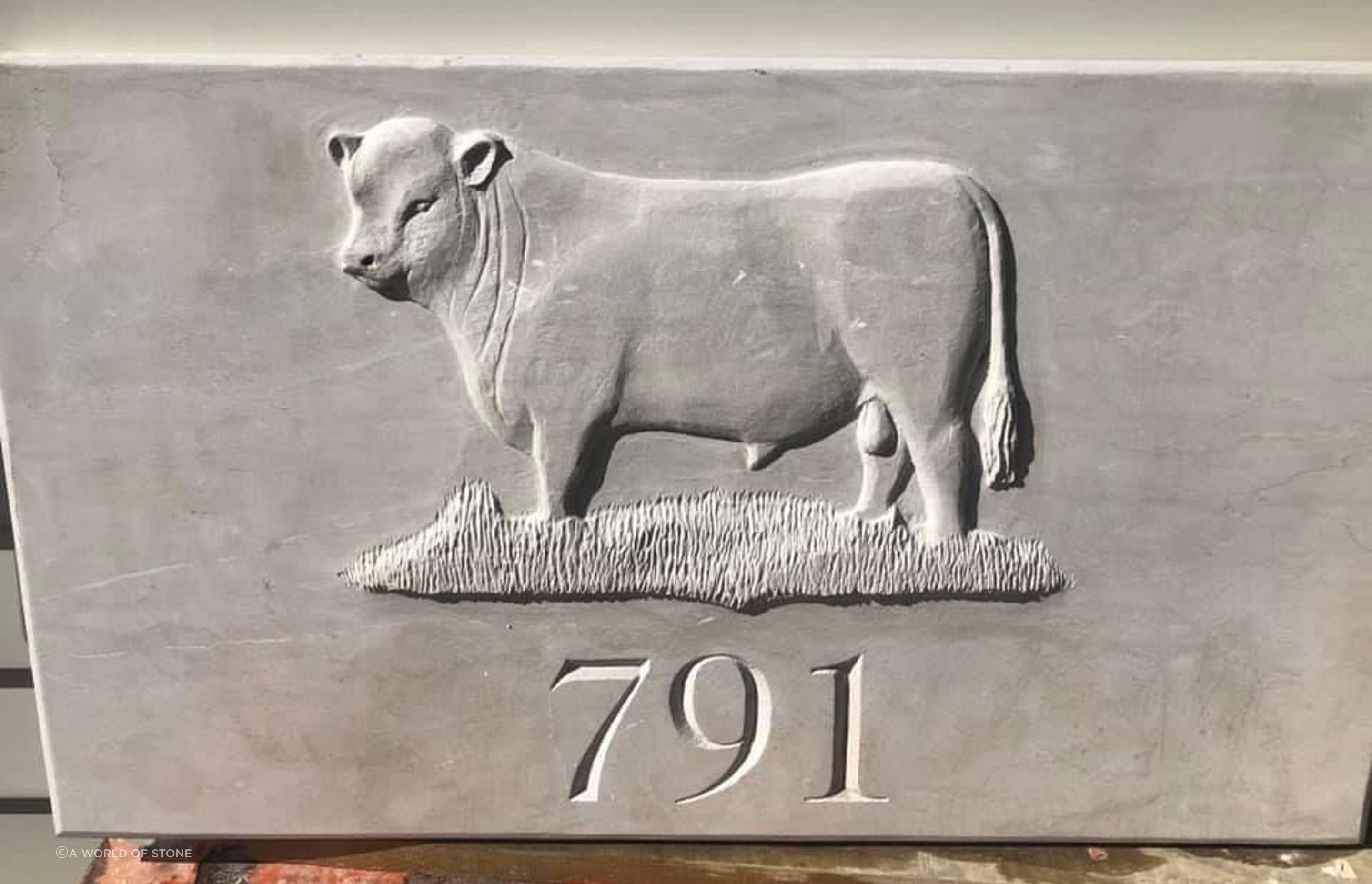 Carved bull and house number in limestone by Paul Gautron