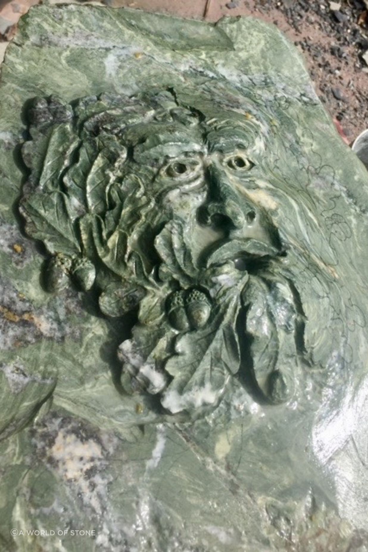 Carved Green man in green schist by Paul Gautron