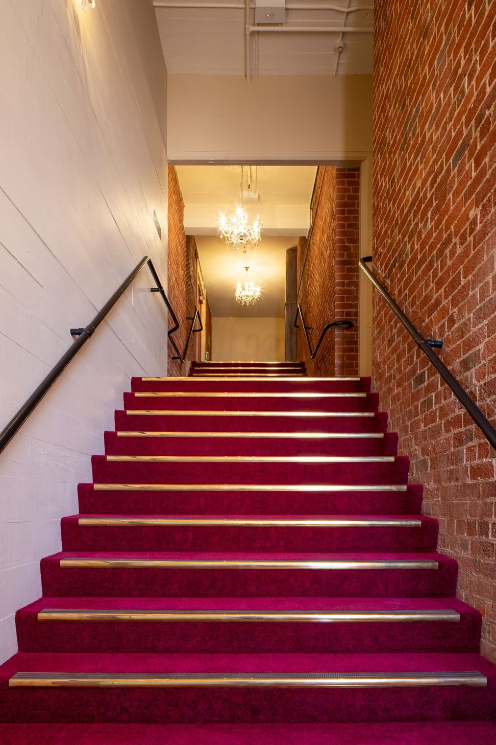 In ancillary spaces such as the stairwells, the new concrete shear walls have been left with the imprint of the rough sawn boards that were used as formwork as a reference to original finishes.