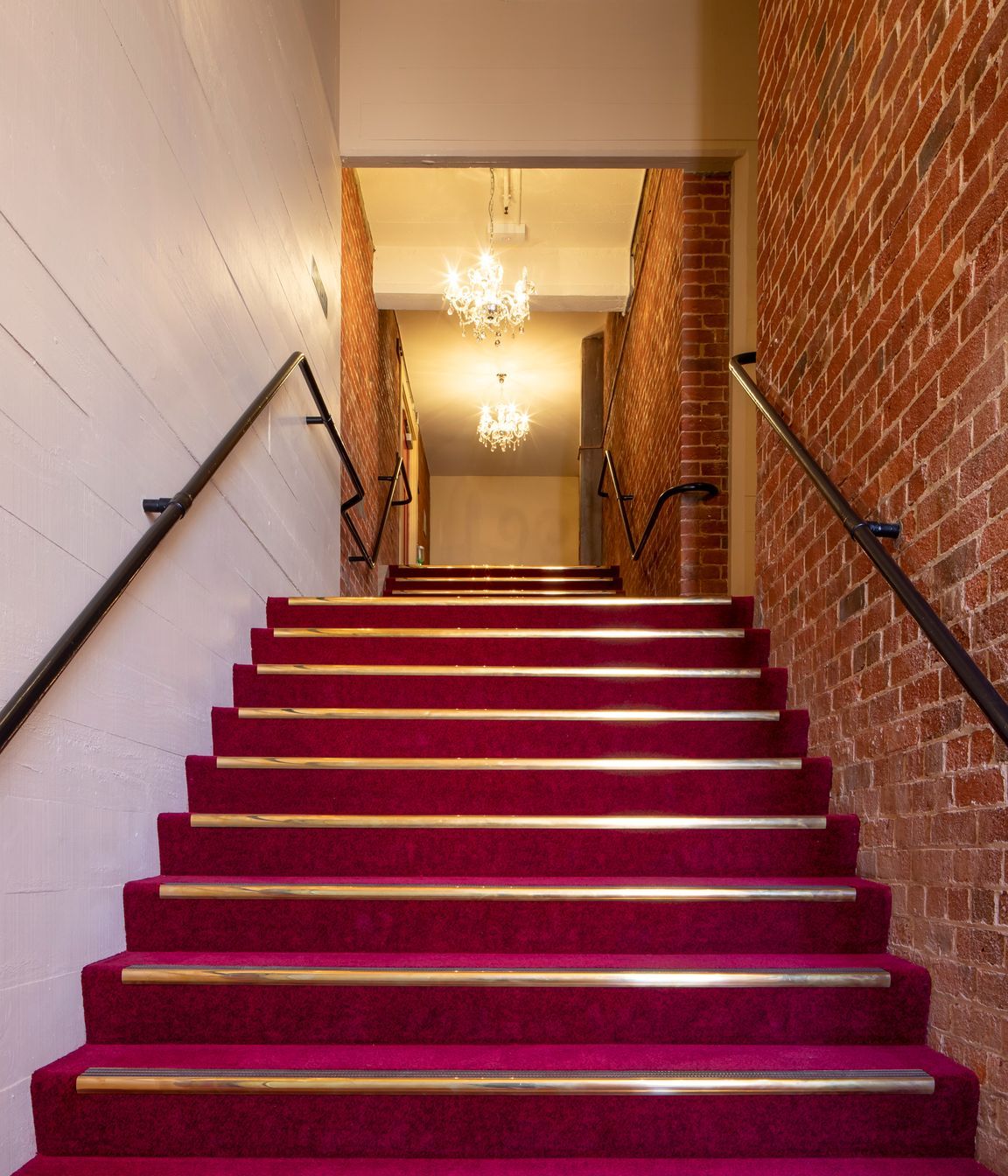 In ancillary spaces such as the stairwells, the new concrete shear walls have been left with the imprint of the rough sawn boards that were used as formwork as a reference to original finishes.