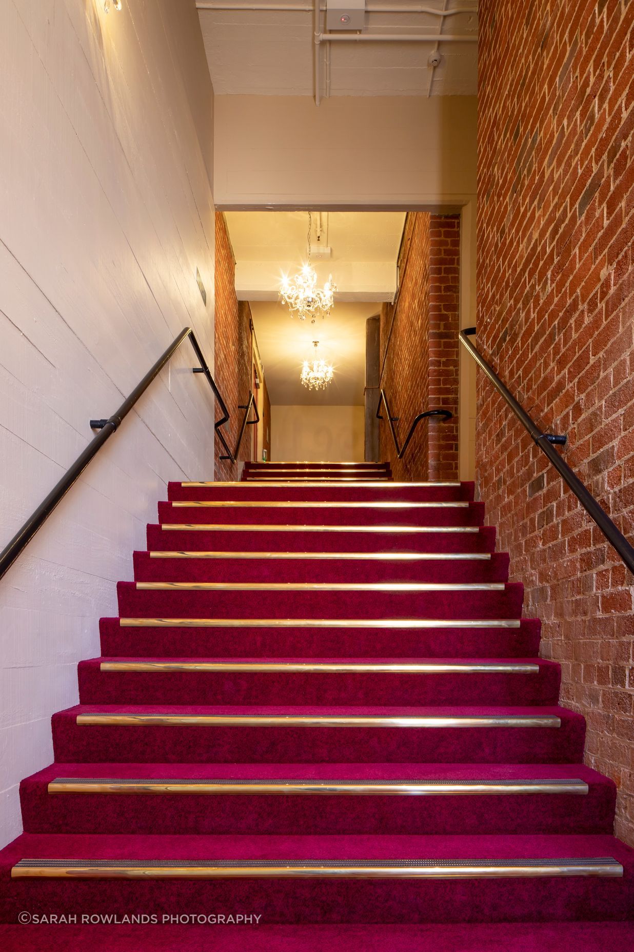 In ancillary spaces such as the stairwells, the new concrete shear walls have been left with the imprint of the rough sawn boards that were used as formwork as a reference to original finishes.