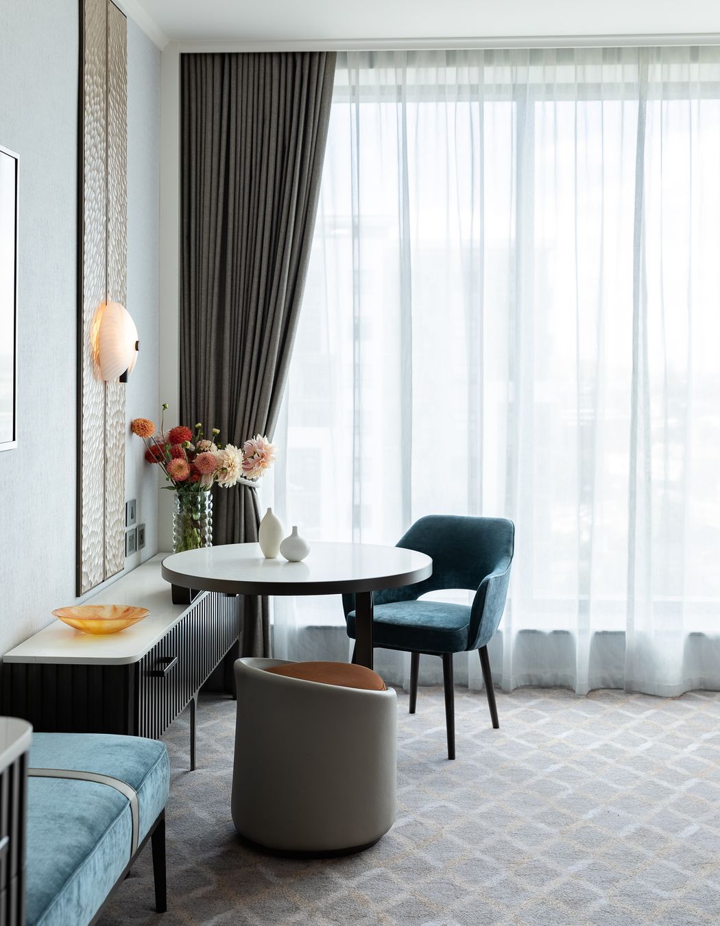 An arrangement of carefully curated furniture and objects creates a feeling of 'home'.