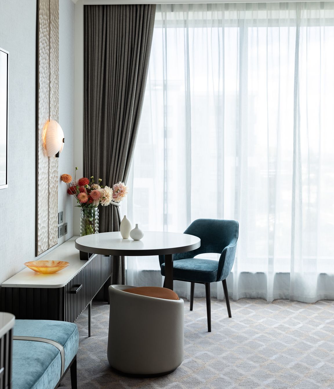 An arrangement of carefully curated furniture and objects creates a feeling of 'home'.
