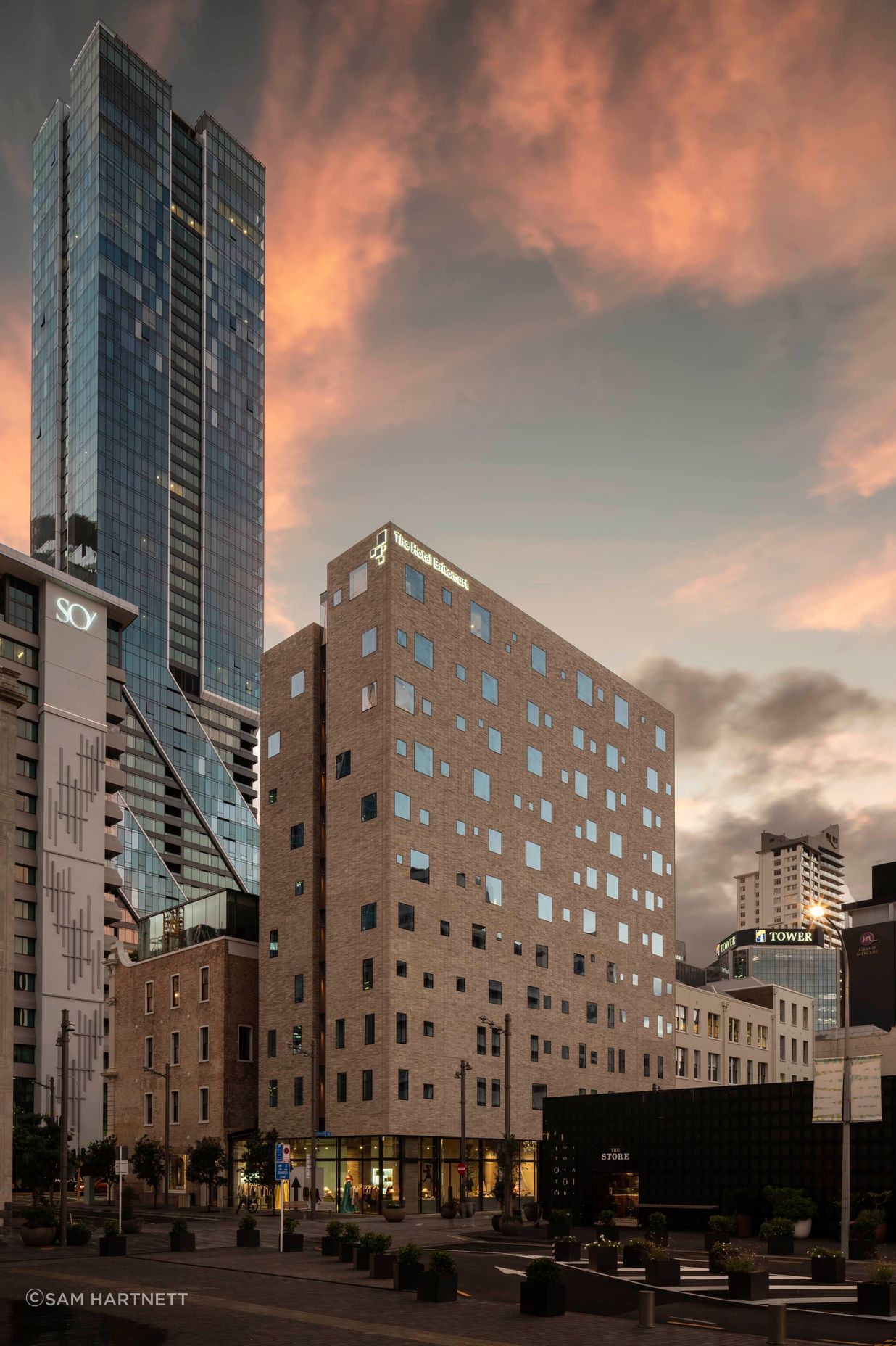 The Hotel Britomart's full brick facade is floating on a glass podium.