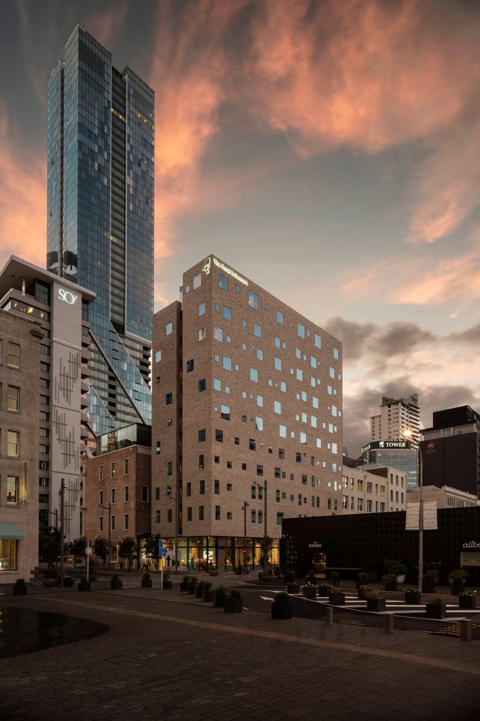 The Hotel Britomart's full brick facade is floating on a glass podium.  Image: Sam Hartnett