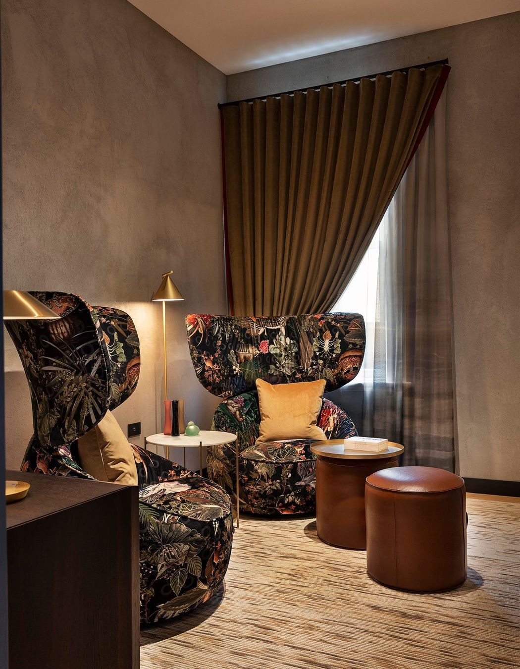 The waiting room features oversized Moooi chairs and leather ottomans for a relaxed and warm reception.