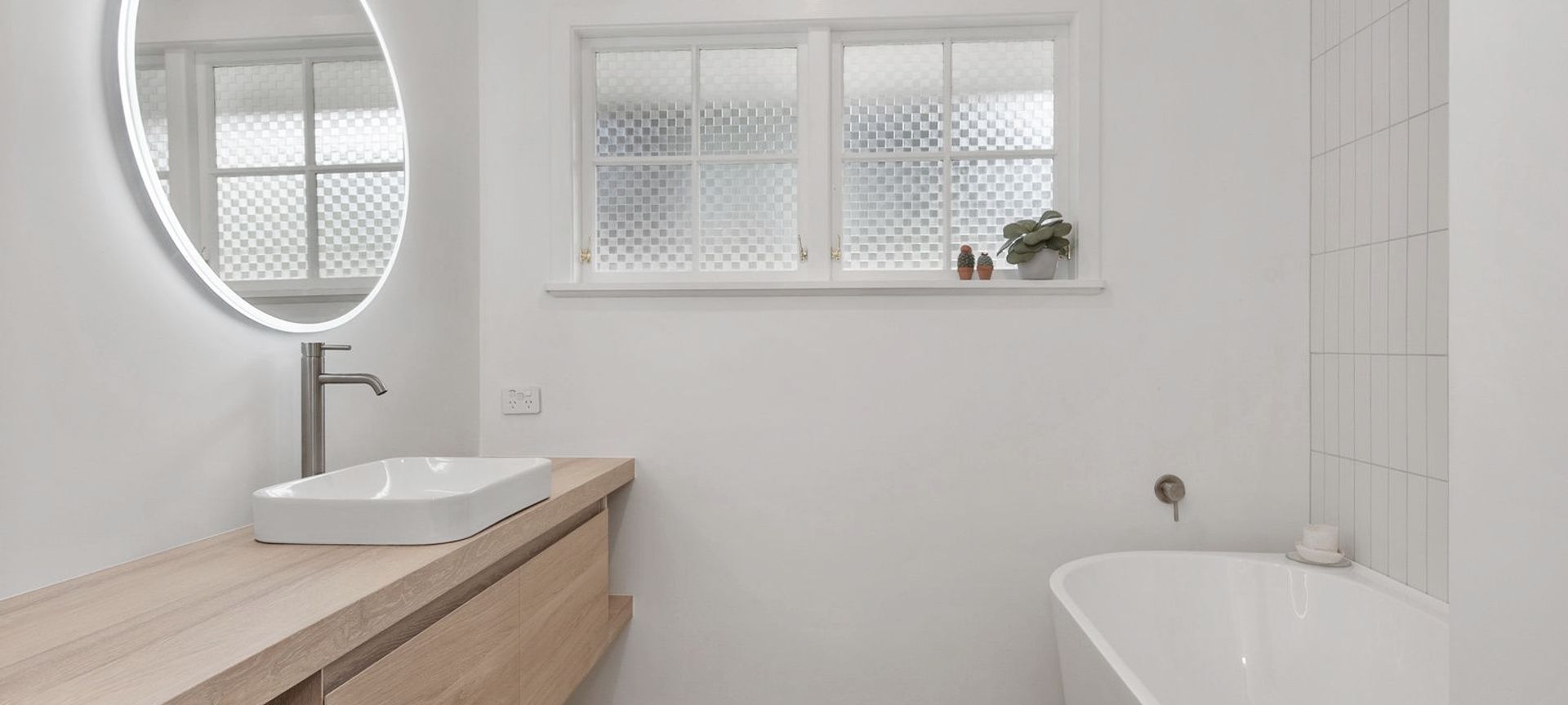 A Lovely Pair of Bathrooms and a Functional Laundry Unit banner