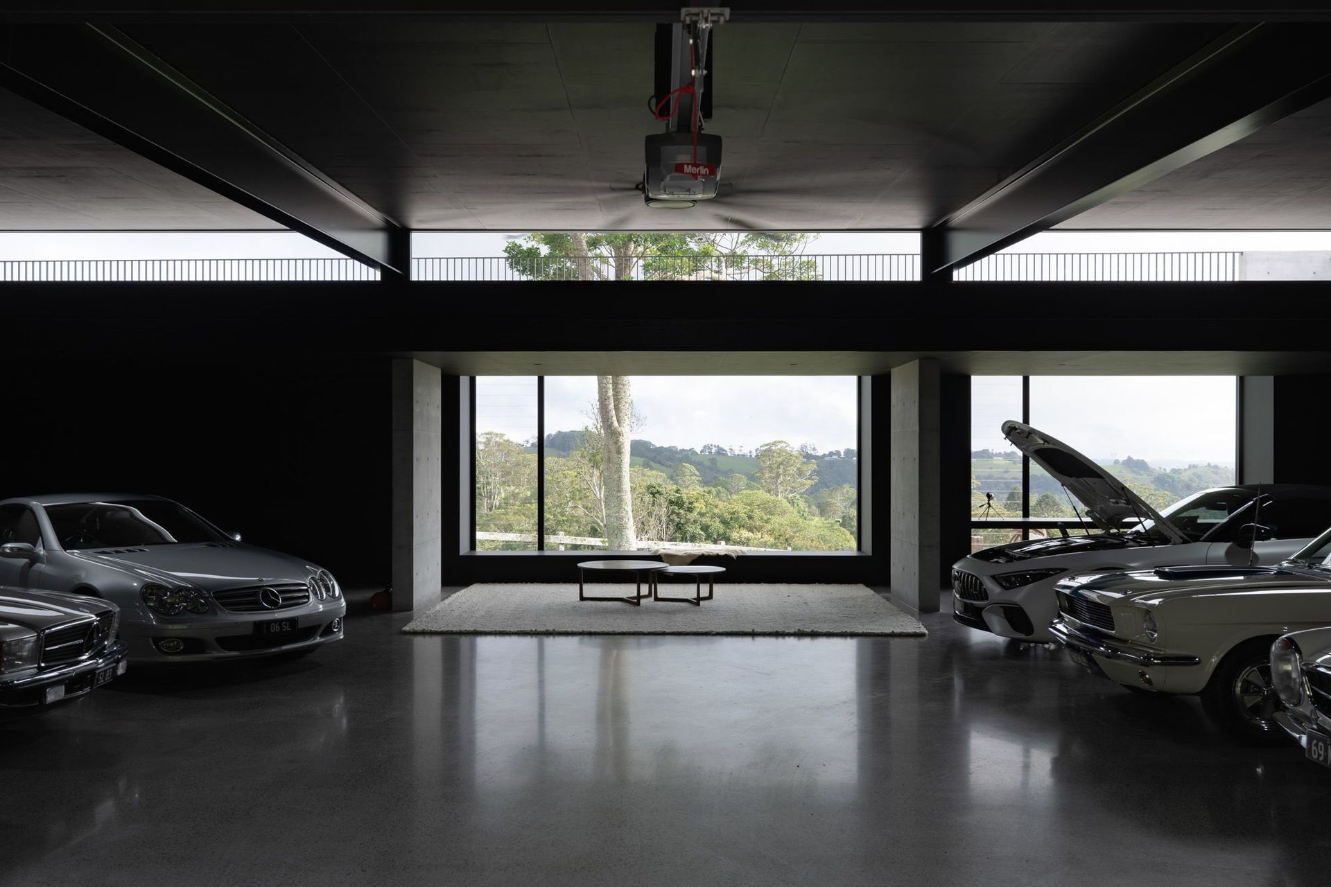 The Farm - Garage. Car gallery with polished concrete floors and a framed rural view.
