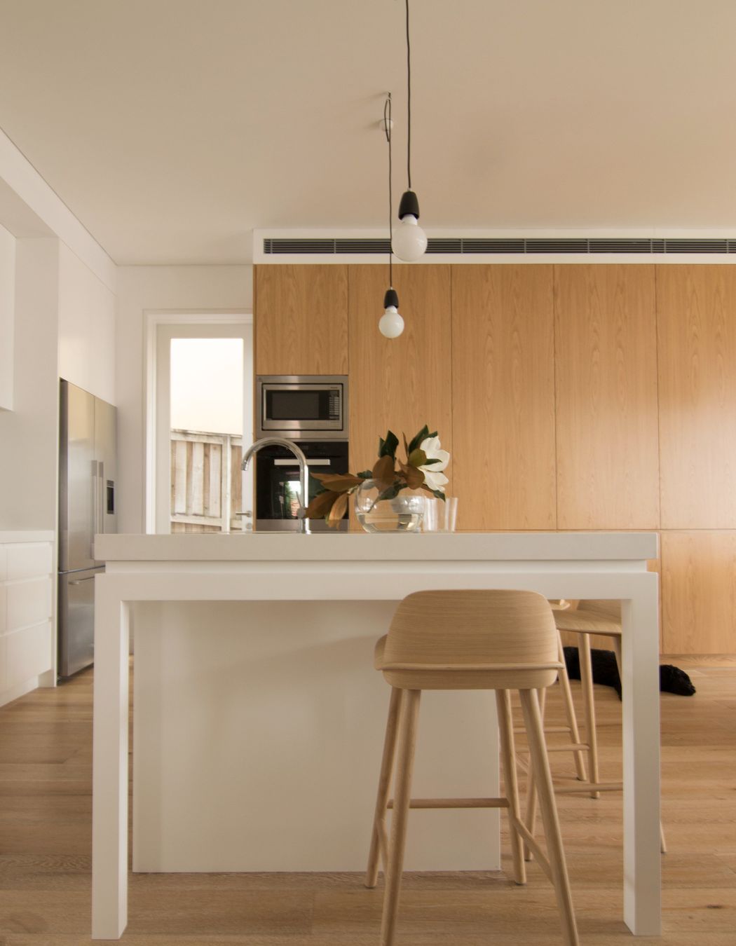 Minimal kitchen with natural and soft finishes.