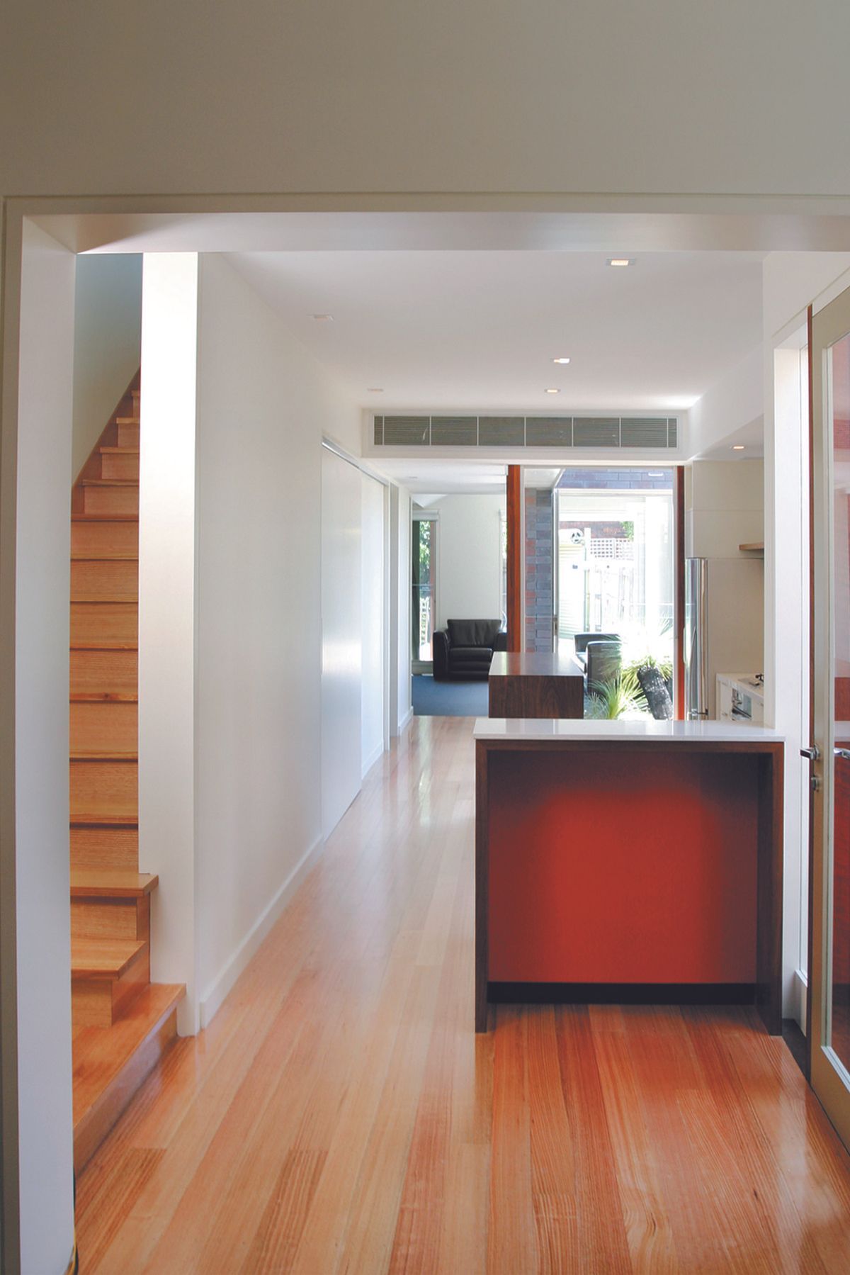 Modern timber kitchen bench and view of integrated courtyard