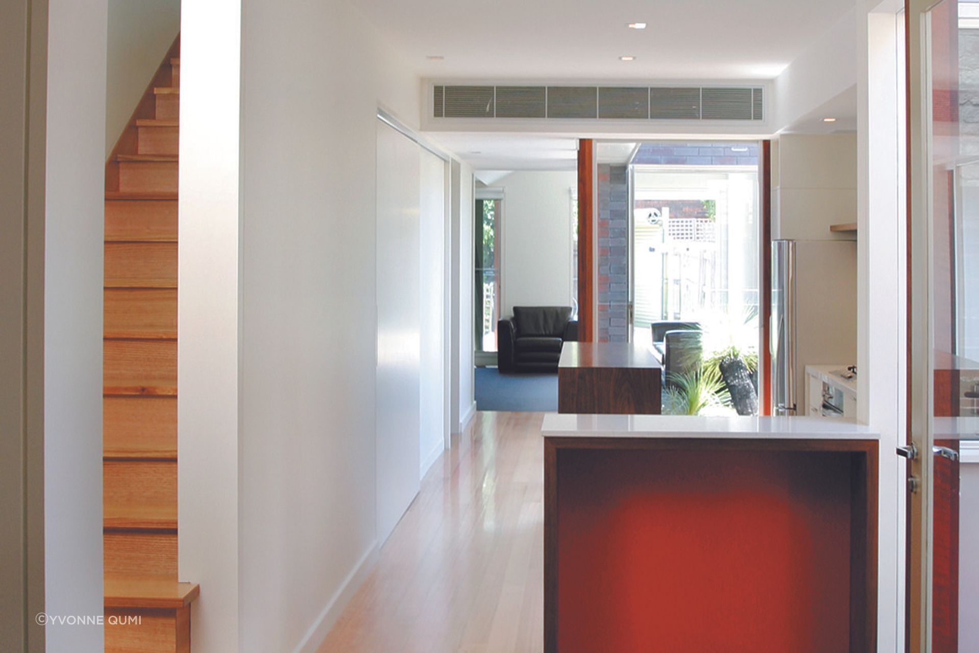Modern timber kitchen bench and view of integrated courtyard