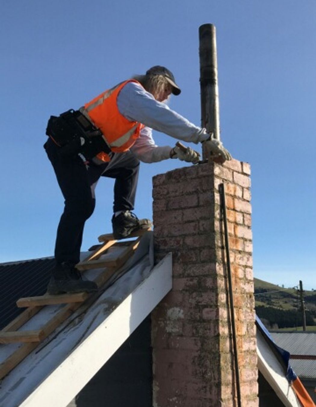 Removing the old damaged chimney down to roof level