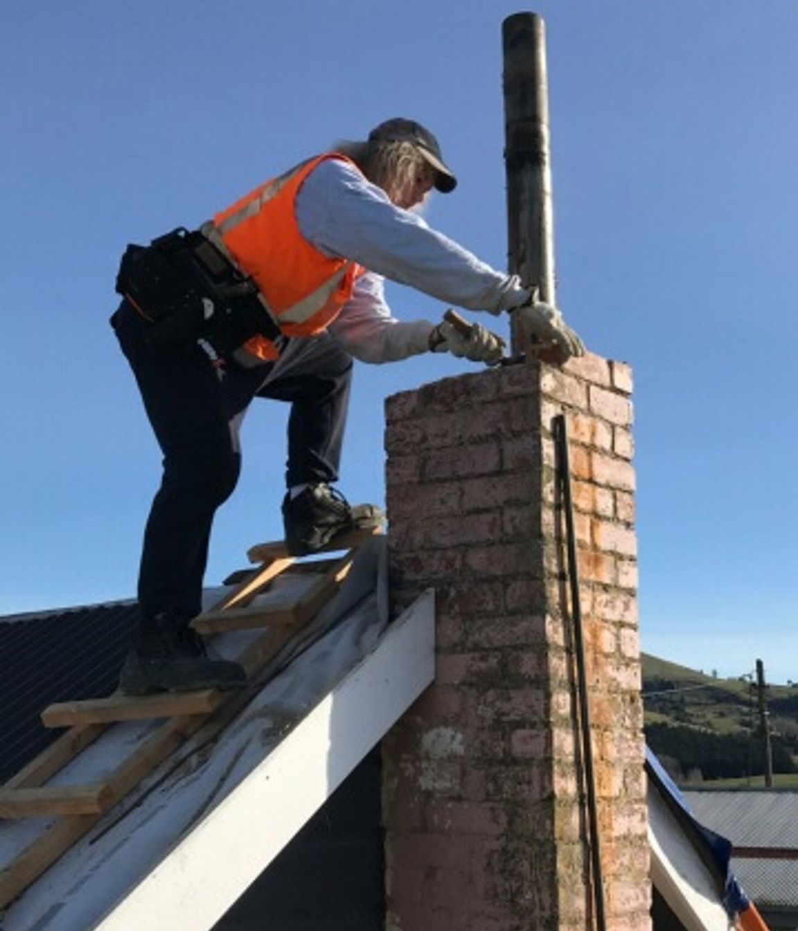 Removing the old damaged chimney down to roof level