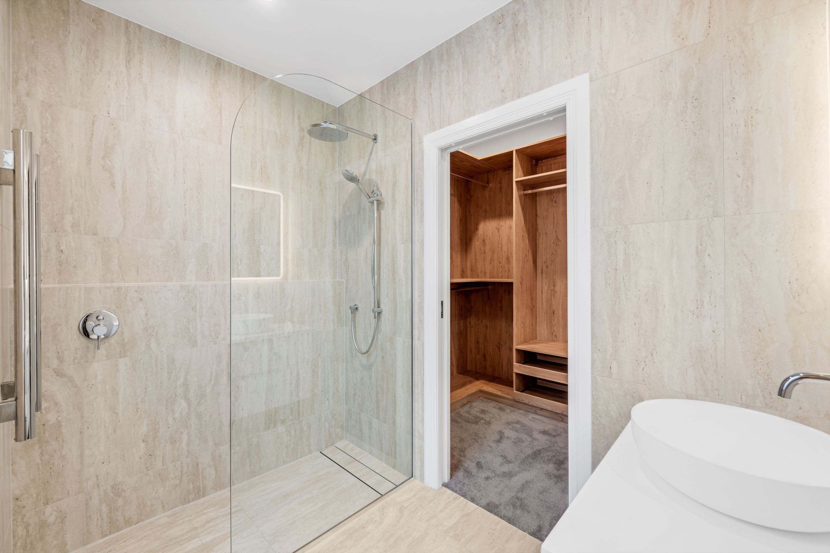 This ensuite was built from scratch. Flush-entry shower, tiled floor to ceiling, and finishes that keep it feeling clean and calm, every day.