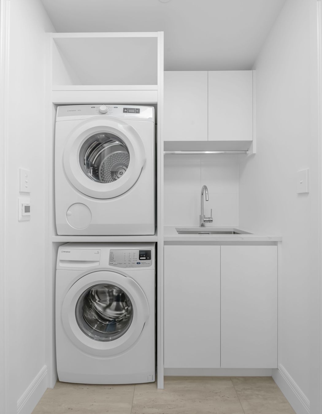 This laundry was designed with everyday life in mind, storage up top, appliances fitted snug, and no wasted space.