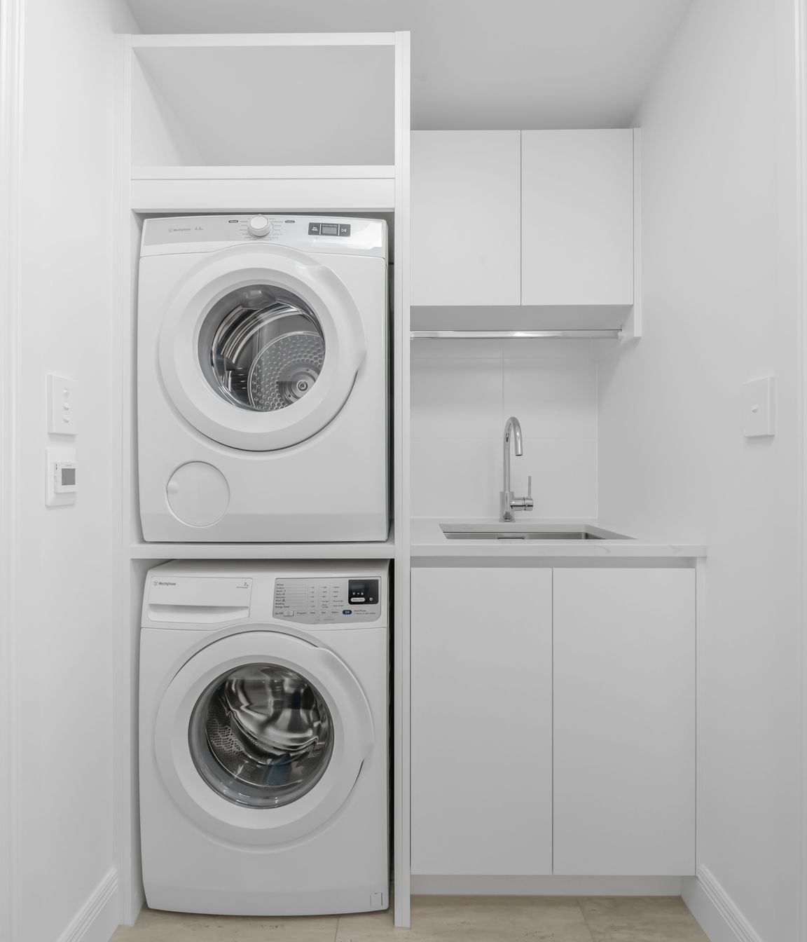 This laundry was designed with everyday life in mind, storage up top, appliances fitted snug, and no wasted space.