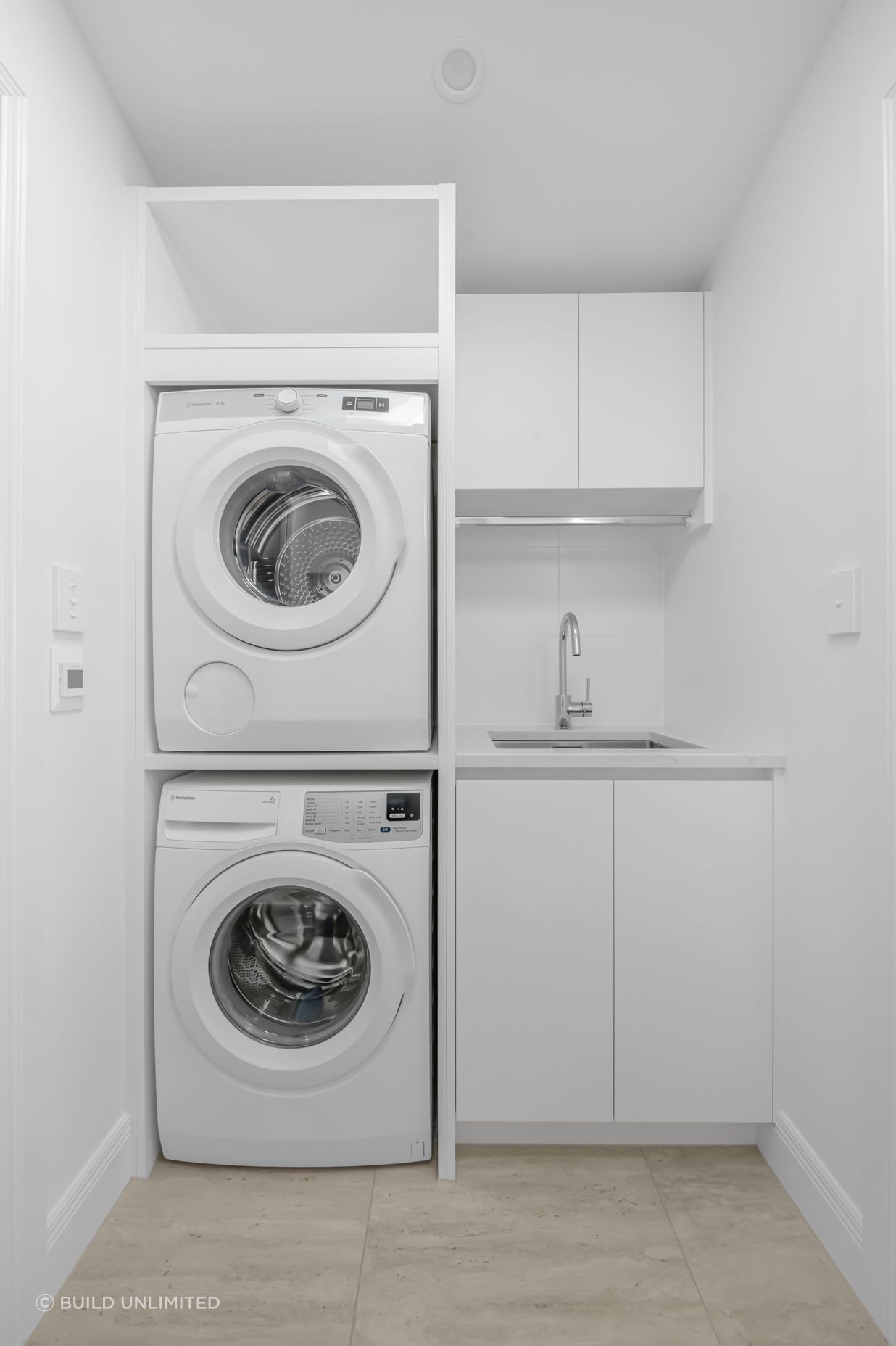 This laundry was designed with everyday life in mind, storage up top, appliances fitted snug, and no wasted space.