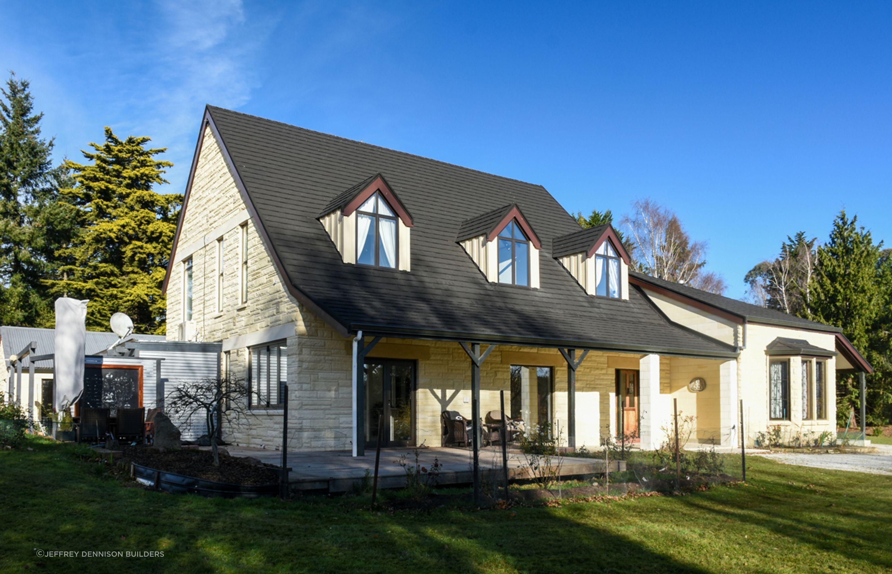 Front three quarter view - new roofing with slate alternative, double-glazed windows, bargeboards over dormer windows, restoration/cleaning of Oamaru stone