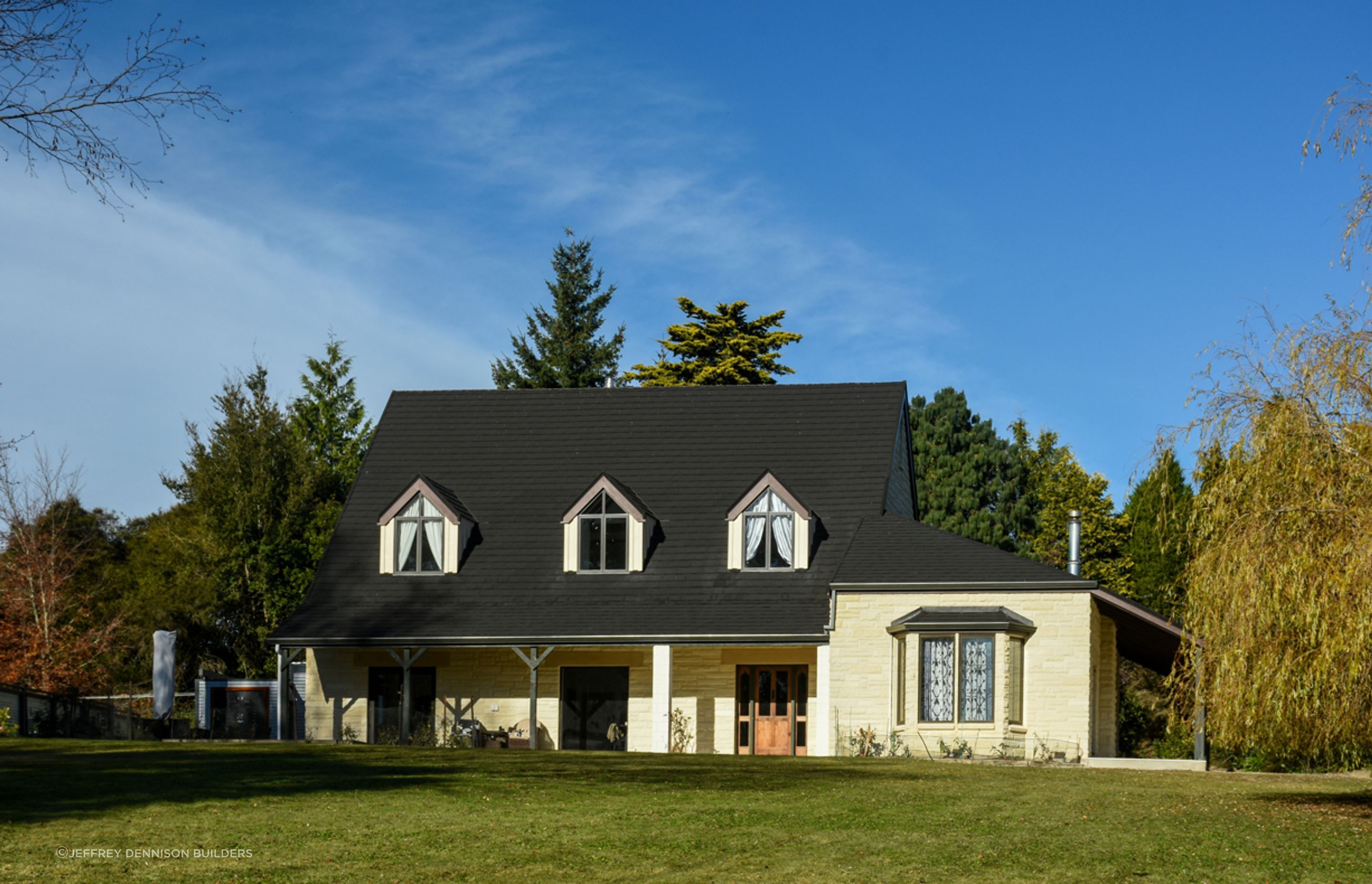 Front view - new roofing with slate alternative, double-glazed windows, bargeboards over dormer windows, restoration/cleaning of Oamaru stone along with porcelain tiles by front door entrance