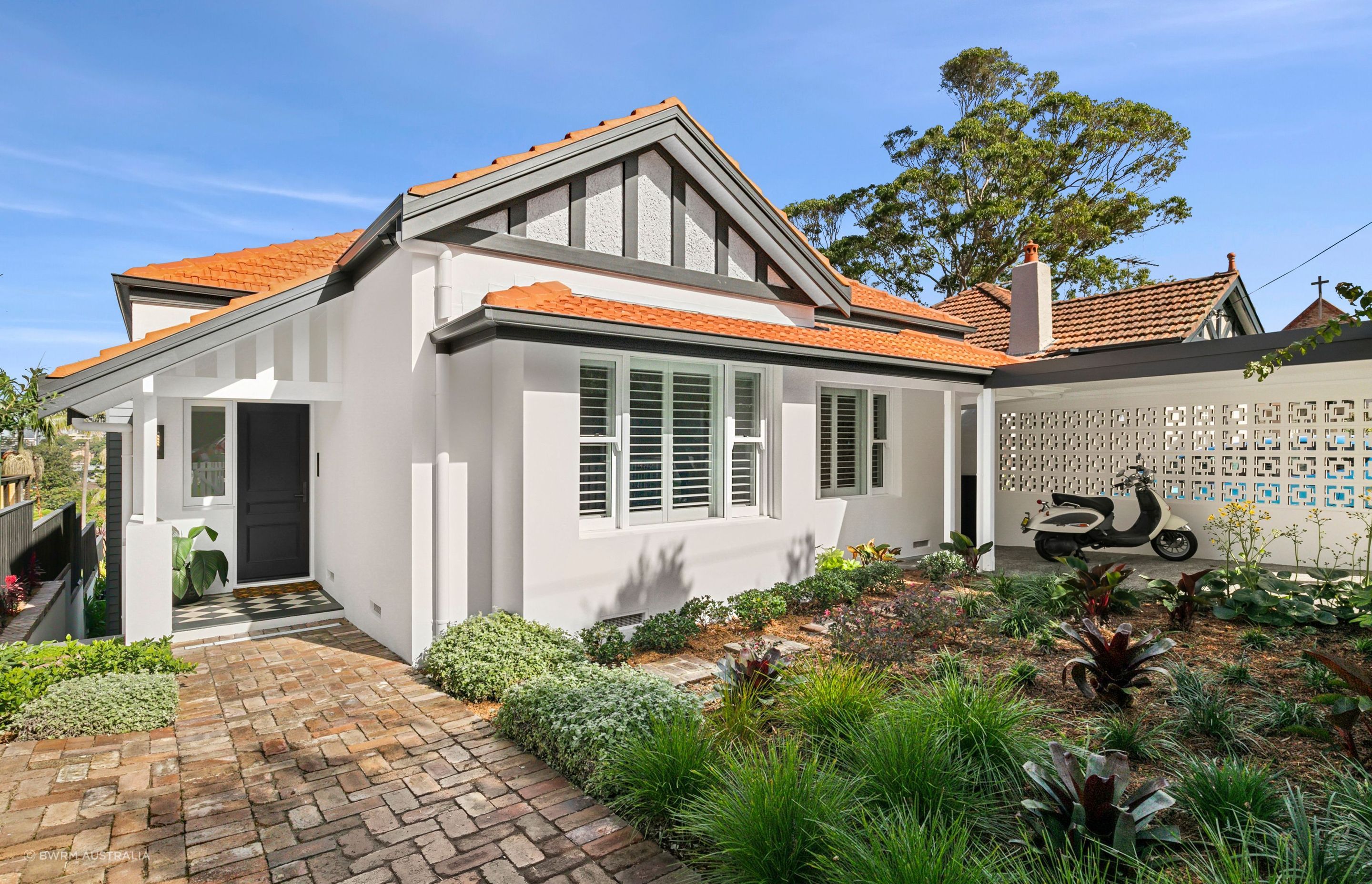 The front of the home retains its modest, traditional character, subtly referencing its original form. This preserved façade anchors the design, providing a quiet counterpoint to the bold, contemporary addition at the rear—reflecting the clients’ vision to harmoniously contrast old with new.