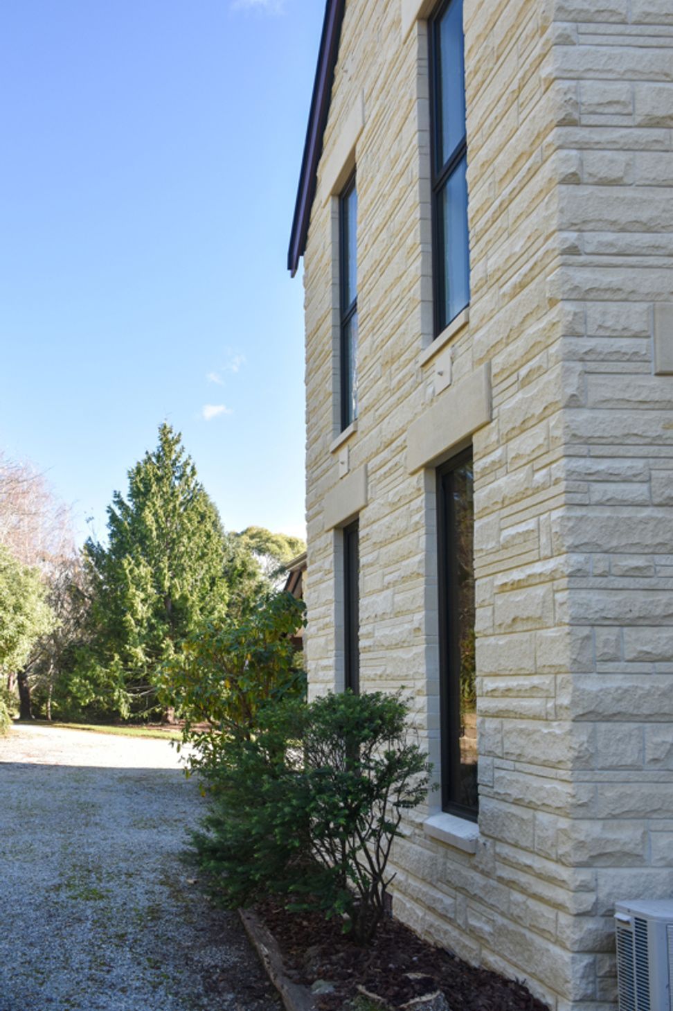 View from the courtyard showing new double-glazed windows, bargeboards and cleaned/restored Oamaru stone looking towards the sublime meandering driveway