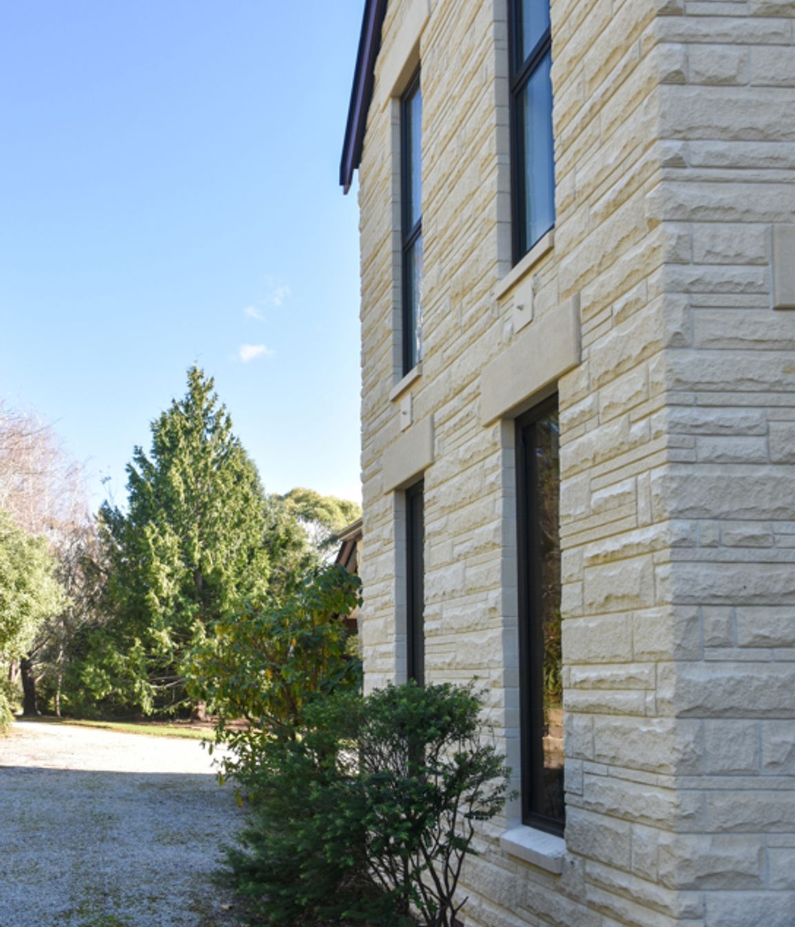 View from the courtyard showing new double-glazed windows, bargeboards and cleaned/restored Oamaru stone looking towards the sublime meandering driveway