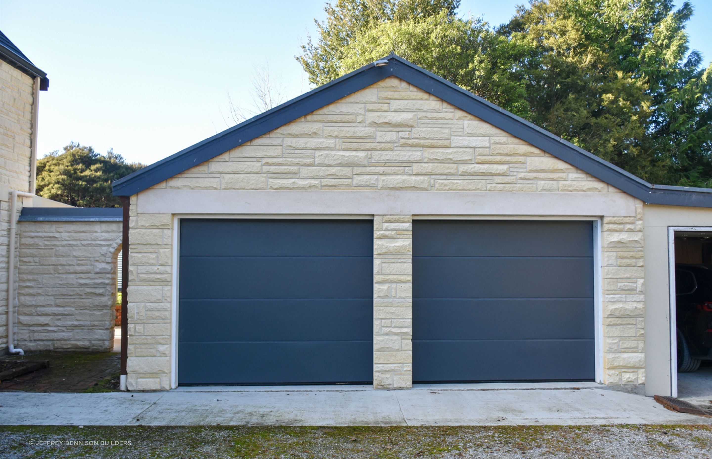View of the garage with cleaned/restored Oamaru stonework.