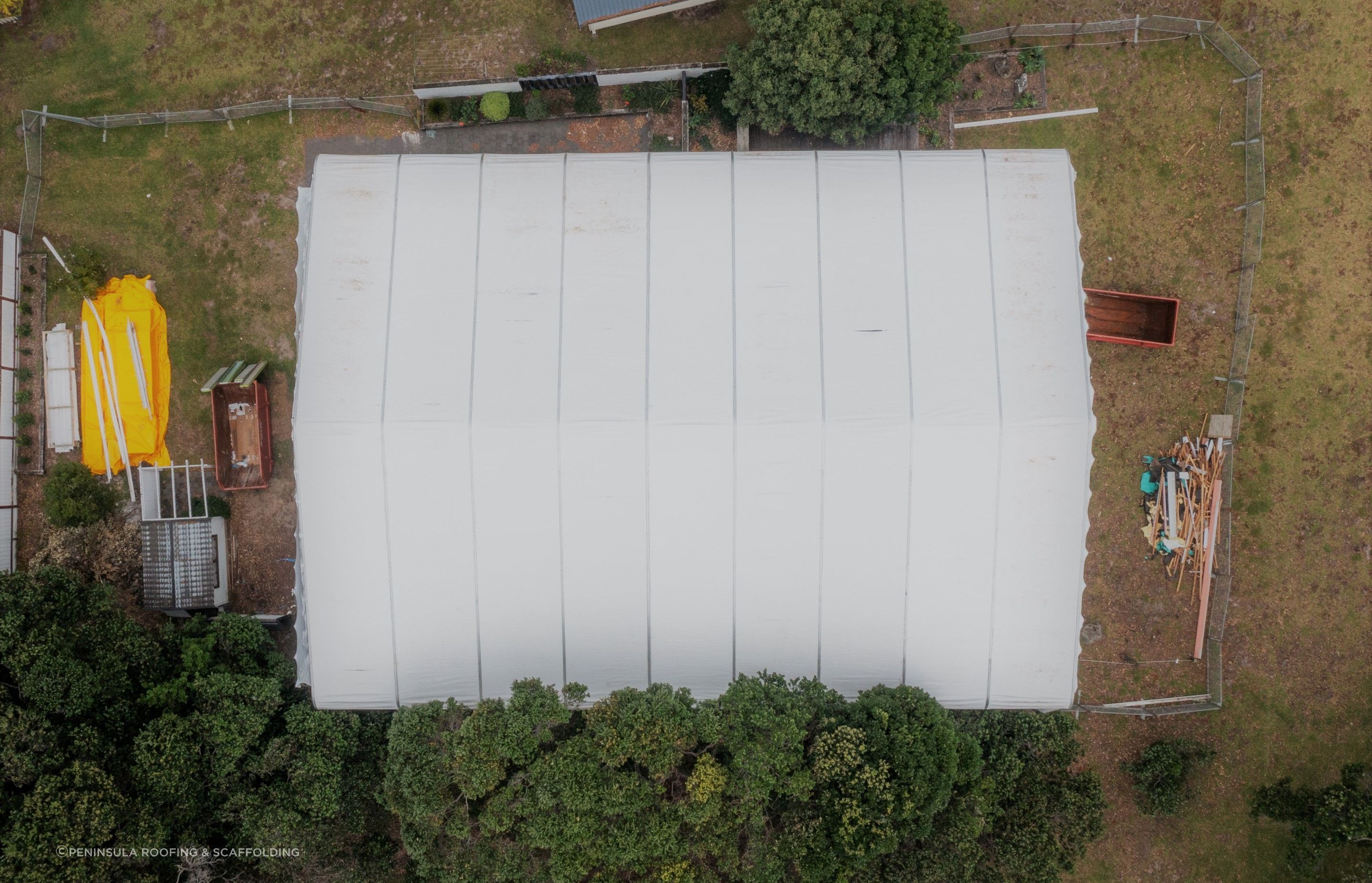 PVC sheet tarpaulins are fed into the supporting structure. They are re-usable!
