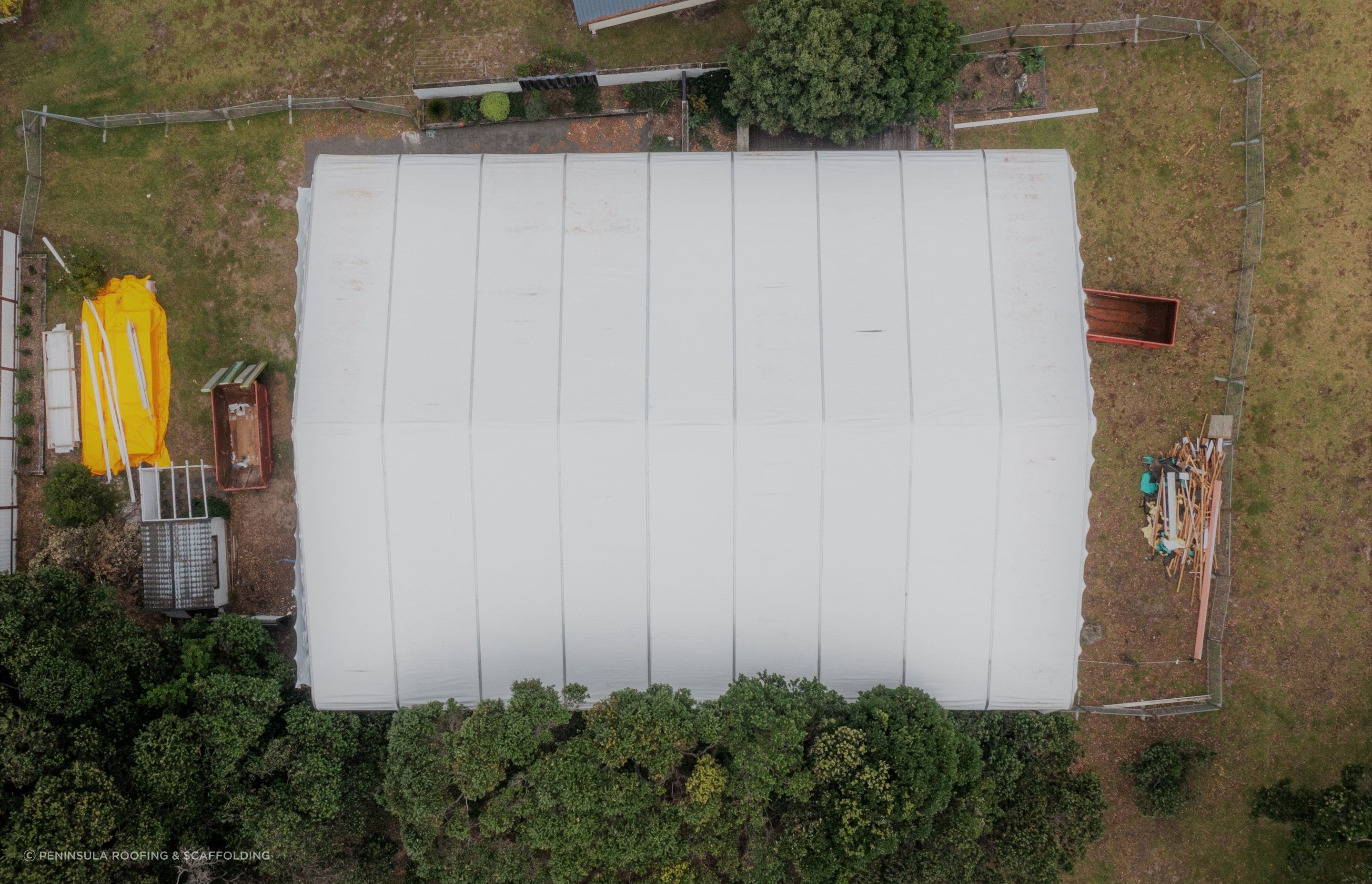 PVC sheet tarpaulins are fed into the supporting structure. They are re-usable!