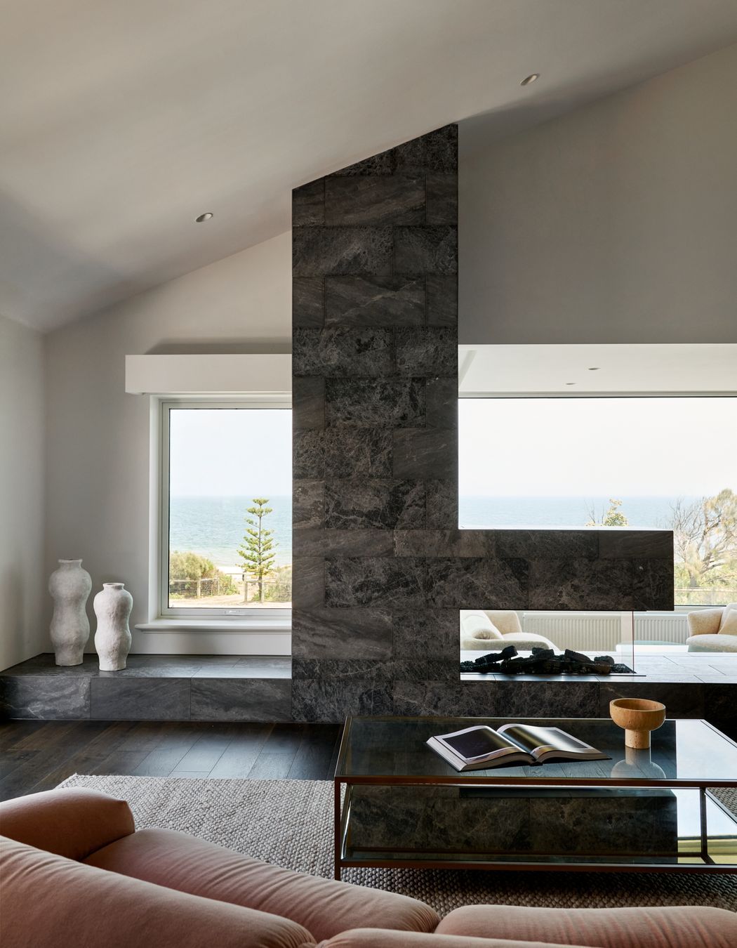 Framed by sweeping bay views, the living room is a place to pause and exhale. Located on the first floor to capture bay views, it is designed to feel open yet grounded. It is the perfect spot for gathering family or simply soaking in the view.