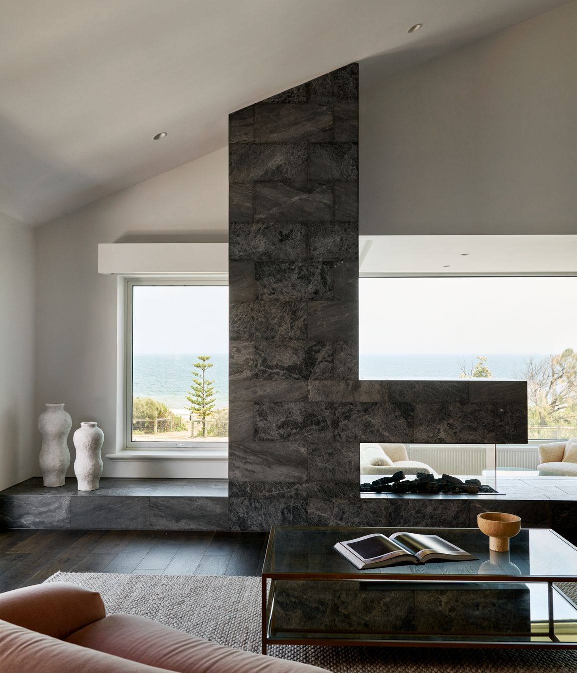 Framed by sweeping bay views, the living room is a place to pause and exhale. Located on the first floor to capture bay views, it is designed to feel open yet grounded. It is the perfect spot for gathering family or simply soaking in the view.