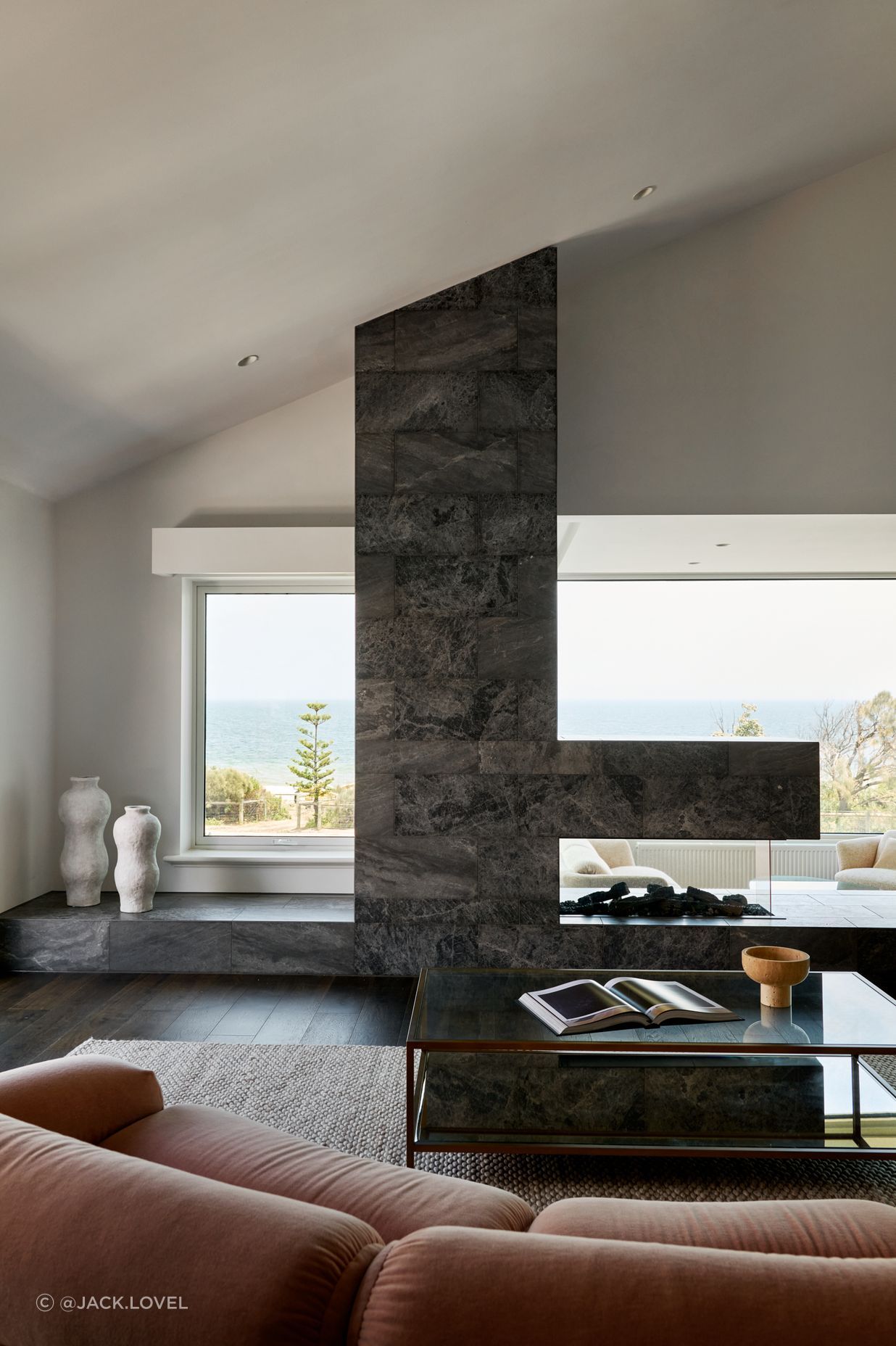 Framed by sweeping bay views, the living room is a place to pause and exhale. Located on the first floor to capture bay views, it is designed to feel open yet grounded. It is the perfect spot for gathering family or simply soaking in the view.