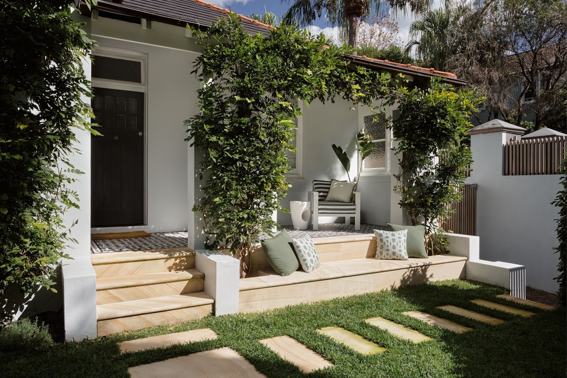 The use of sandstone and tessellated tiles on the front porch maintains character of a federation home of the era.