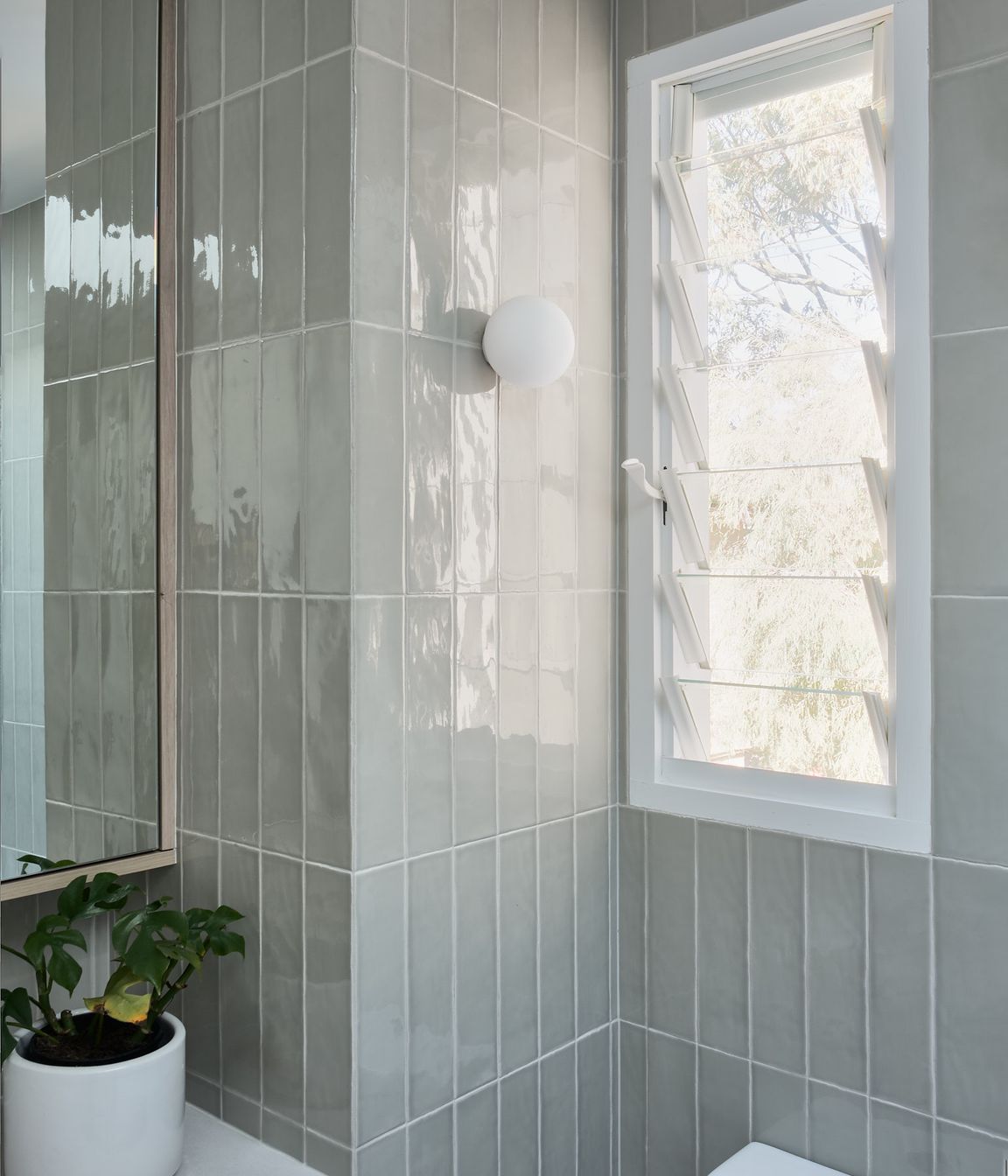The tone enhances the natural feel connecting the interior with the tree canopy views through the windows.