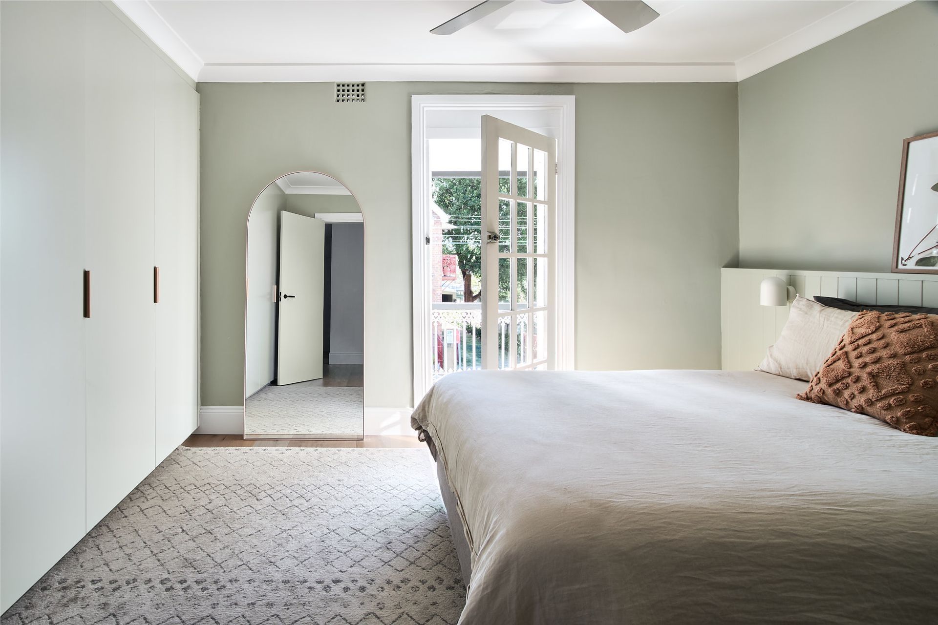 Graced with the same green hue, access to the street-facing balcony on the home's northern side is via the main bedroom.