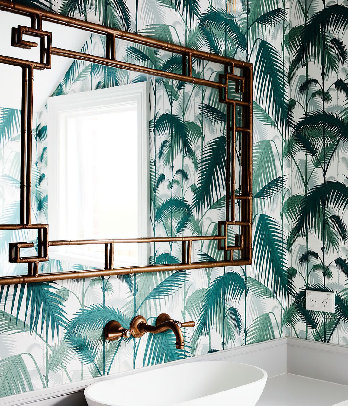 BAMBOO FRAMED MIRROR - This bamboo framed mirror had to be specially hung due to its great weight.  A fantastic hint of British colonial style in this powder room.