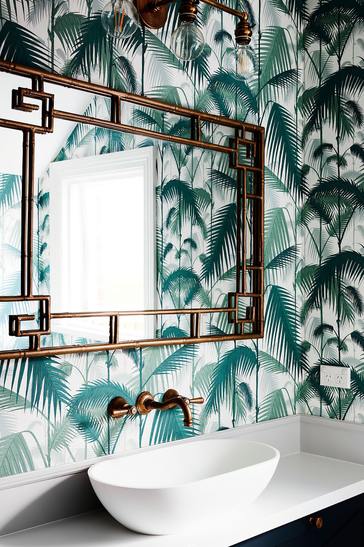 BAMBOO FRAMED MIRROR - This bamboo framed mirror had to be specially hung due to its great weight. A fantastic hint of British colonial style in this powder room.