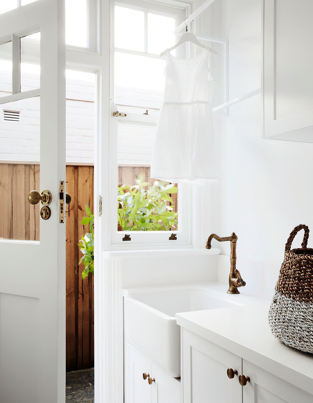 WHITE LAUNDRY - This white laundry features a butlers sink to complement the kitchen, similar tapware and mosaic tiling. It is highly functional and beautiful.