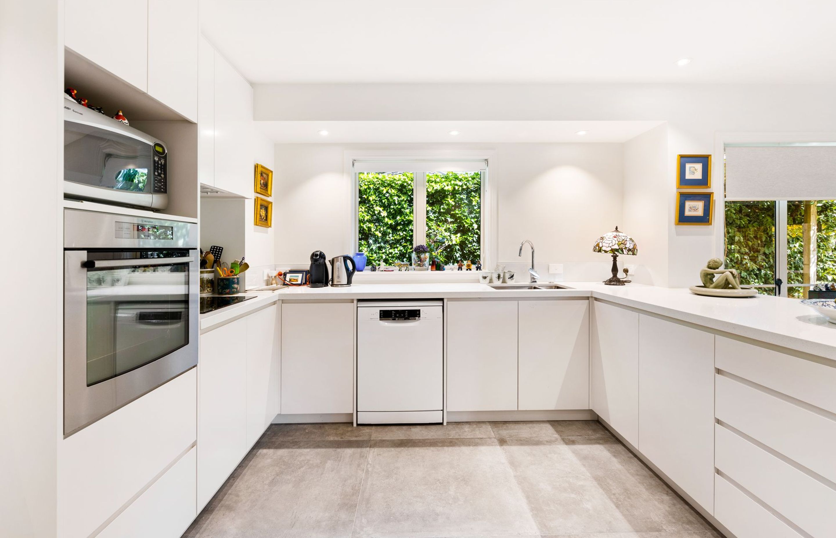 External wall pushed out to the fascia line. Partition wall removed and replaced by breakfast bar. New kitchen cabinetry with touch-open doors.