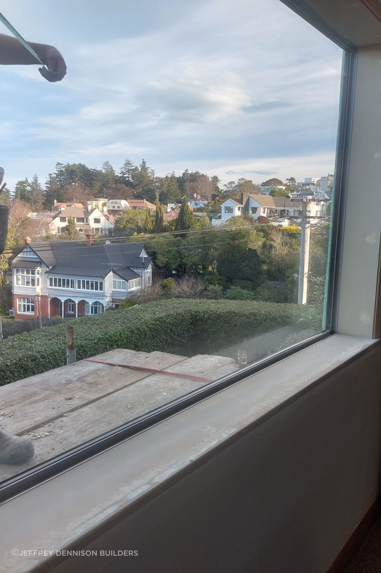 7-19-Tweed-St-Roslyn-Dunedin-Newly-installed-double-glazed-window-in-the-loungeroom-being-stopped-and-sanded-in-the-interior-with-the-exterior-flashings-being-measured-.jpg