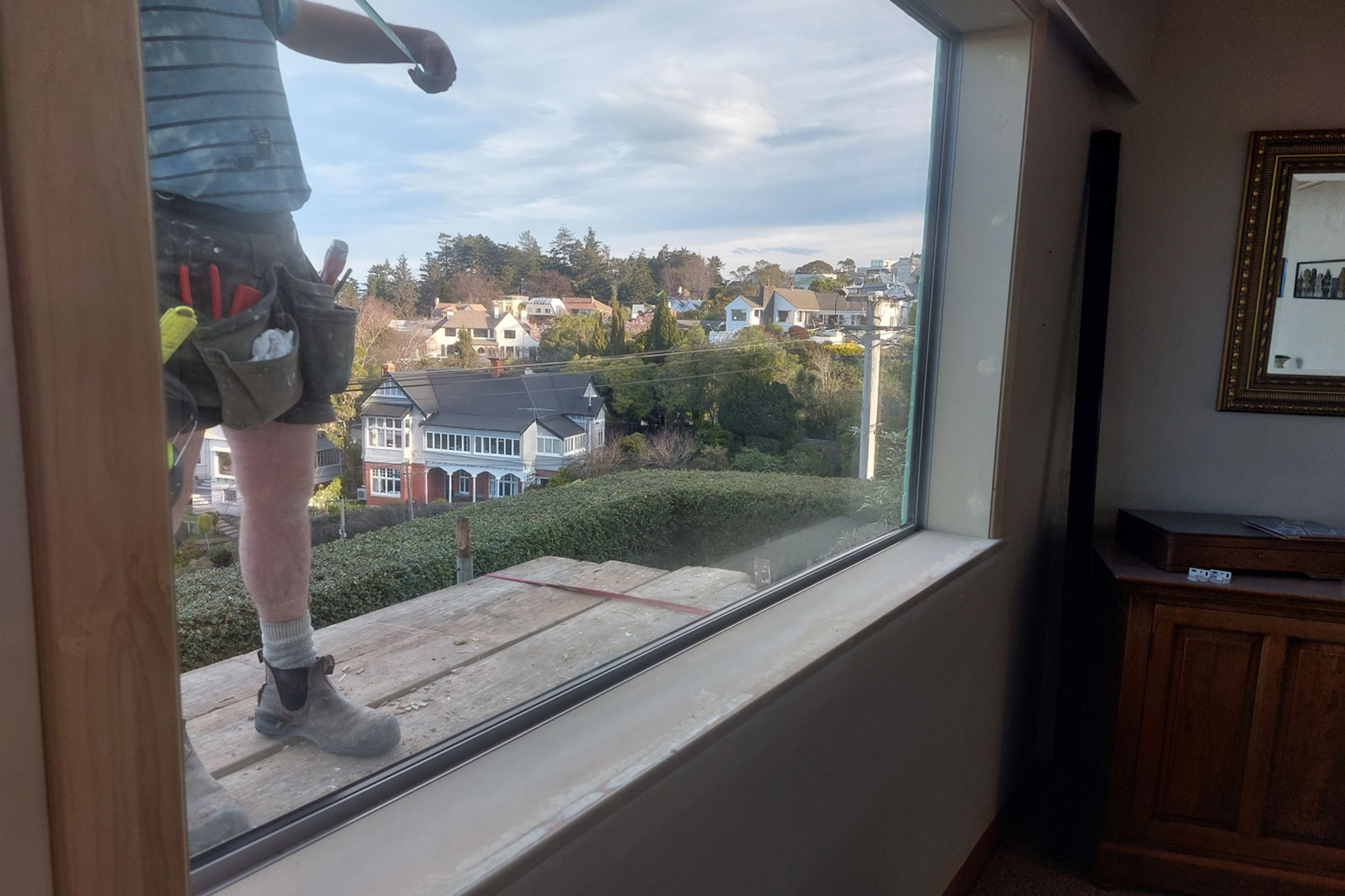 7-19-Tweed-St-Roslyn-Dunedin-Newly-installed-double-glazed-window-in-the-loungeroom-being-stopped-and-sanded-in-the-interior-with-the-exterior-flashings-being-measured-.jpg
