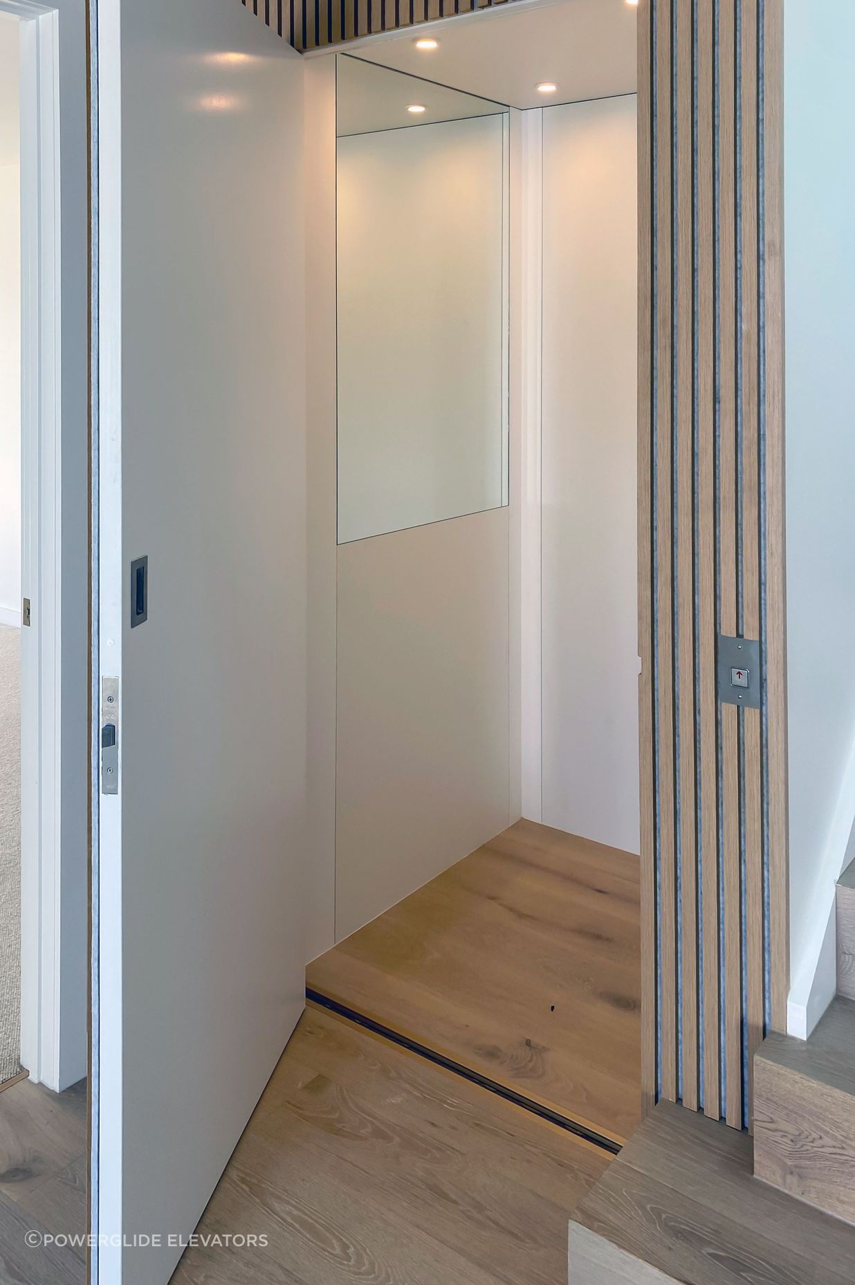 A half height mirror creates a feeling of space and the timber flooring matches the flooring in the hallway.